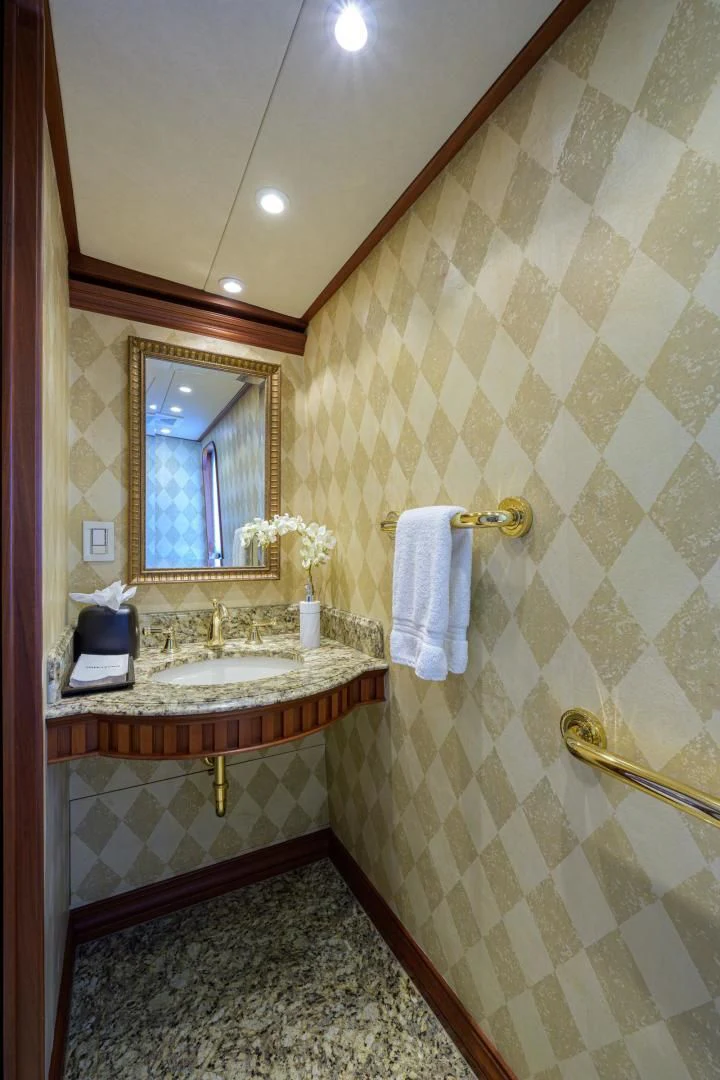 a bathroom with a sink and mirror aboard LEGACY Yacht for Sale
