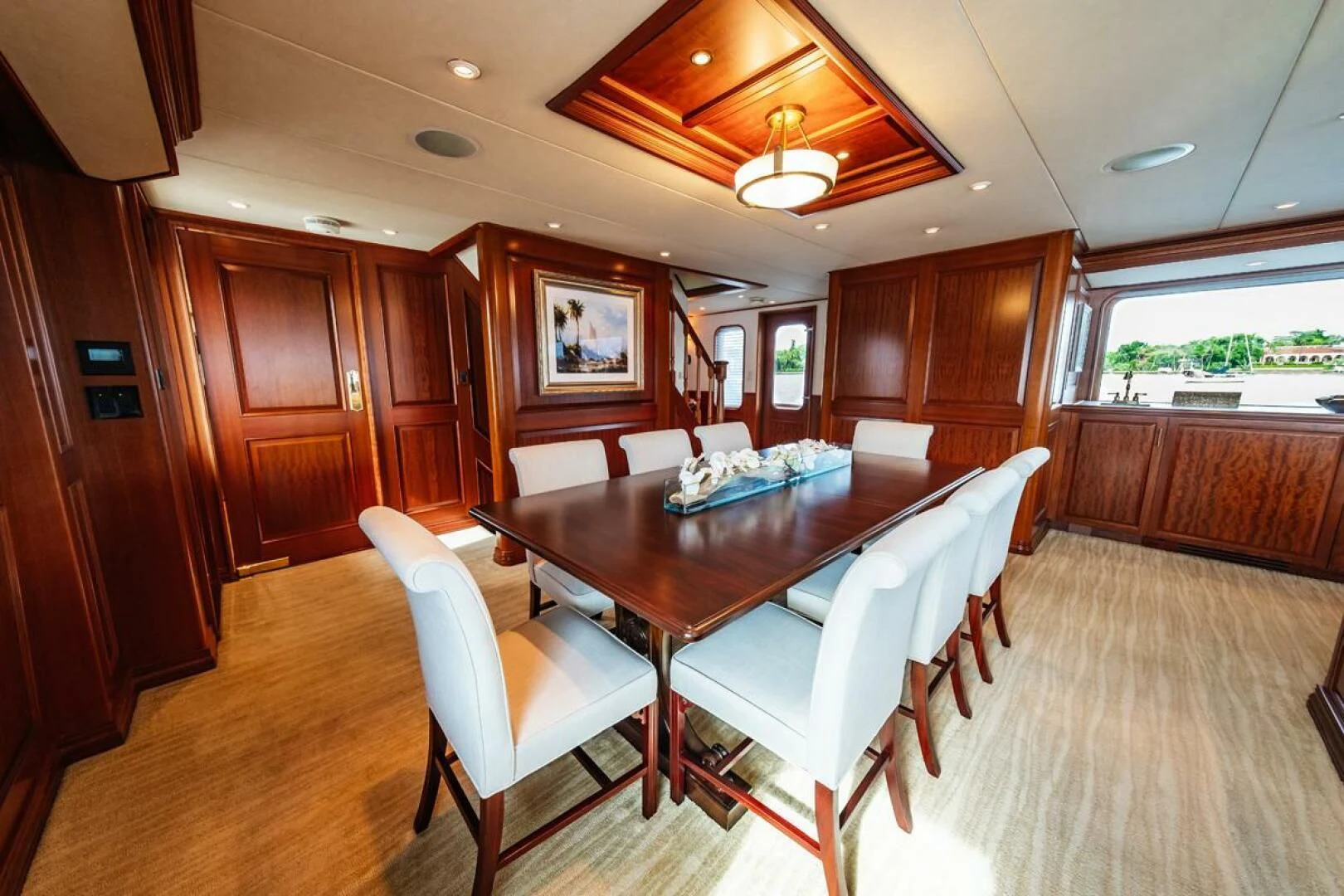 a large room with a table and chairs aboard LEGACY Yacht for Sale