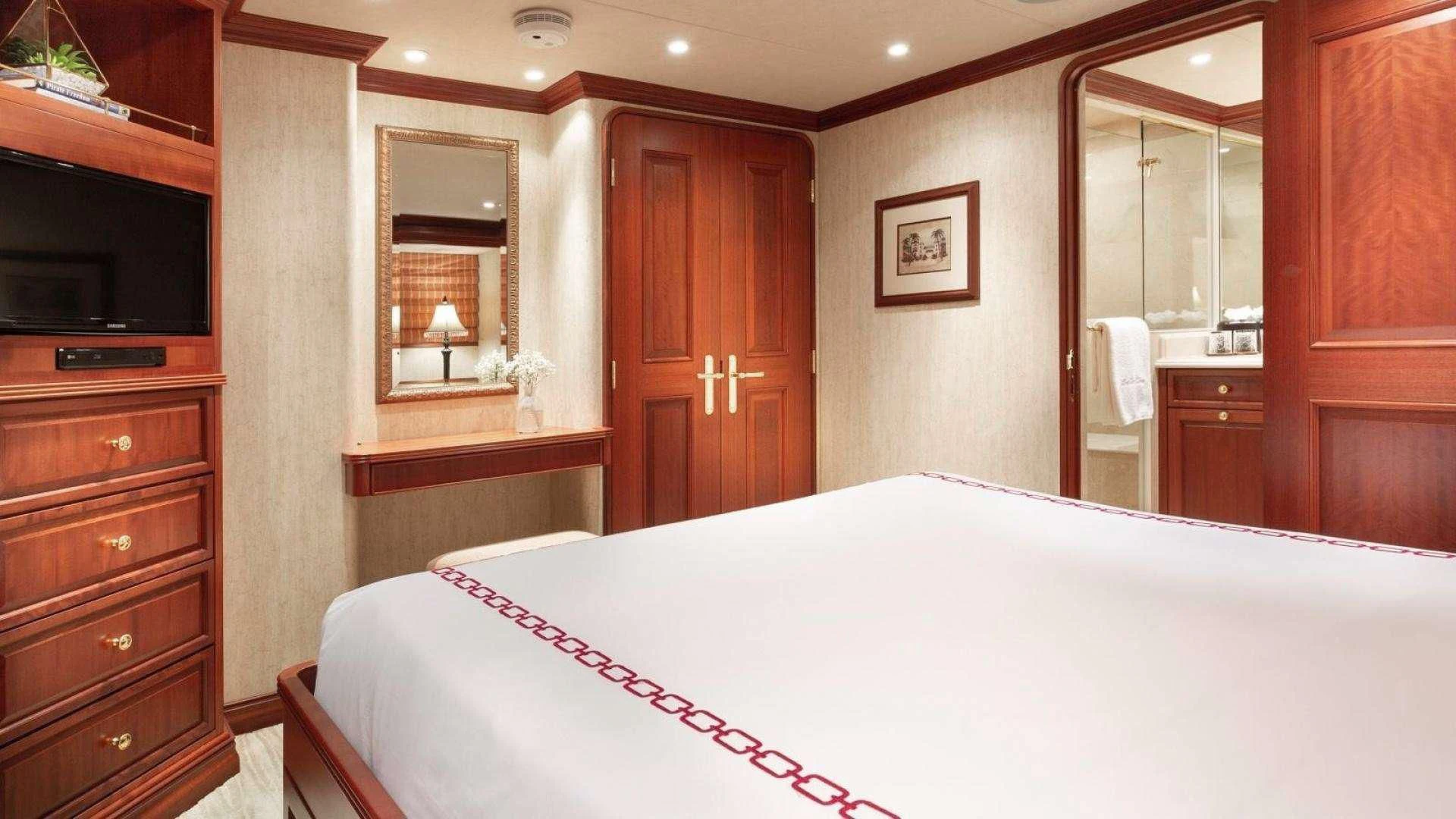 a large bedroom with a large bed aboard LEGACY Yacht for Sale