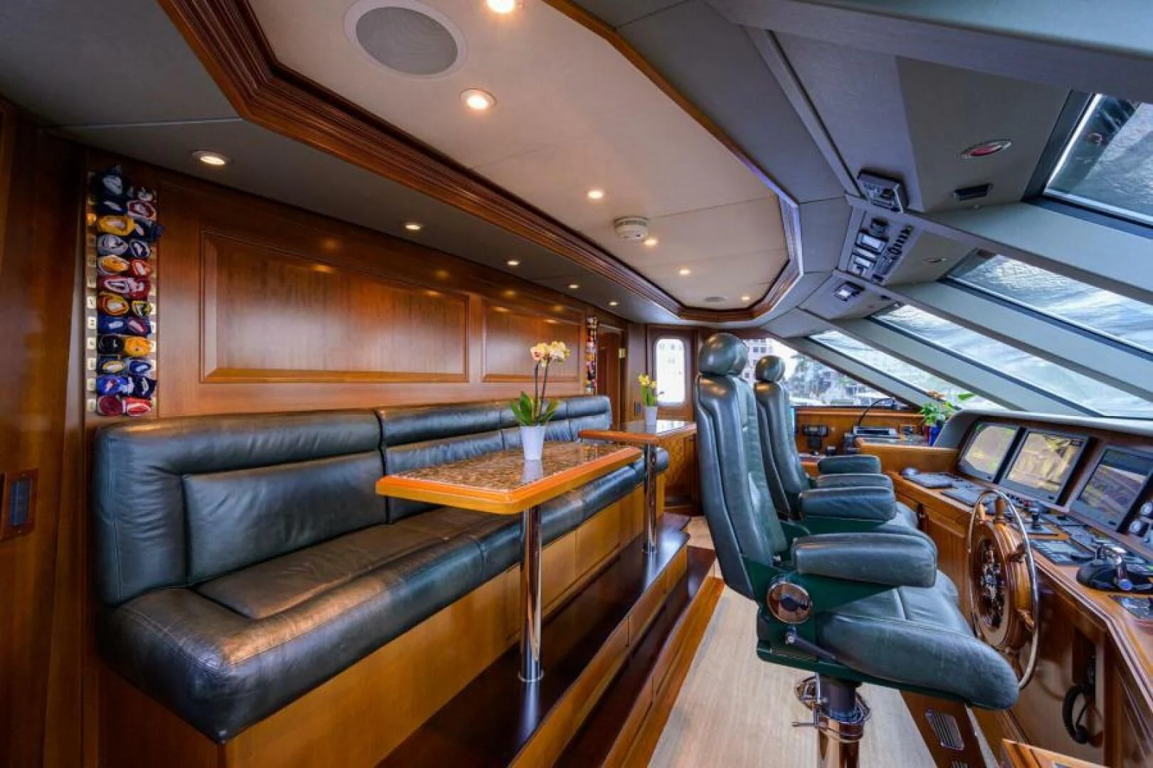 a room with a leather couch and a table with chairs aboard LEGACY Yacht for Sale