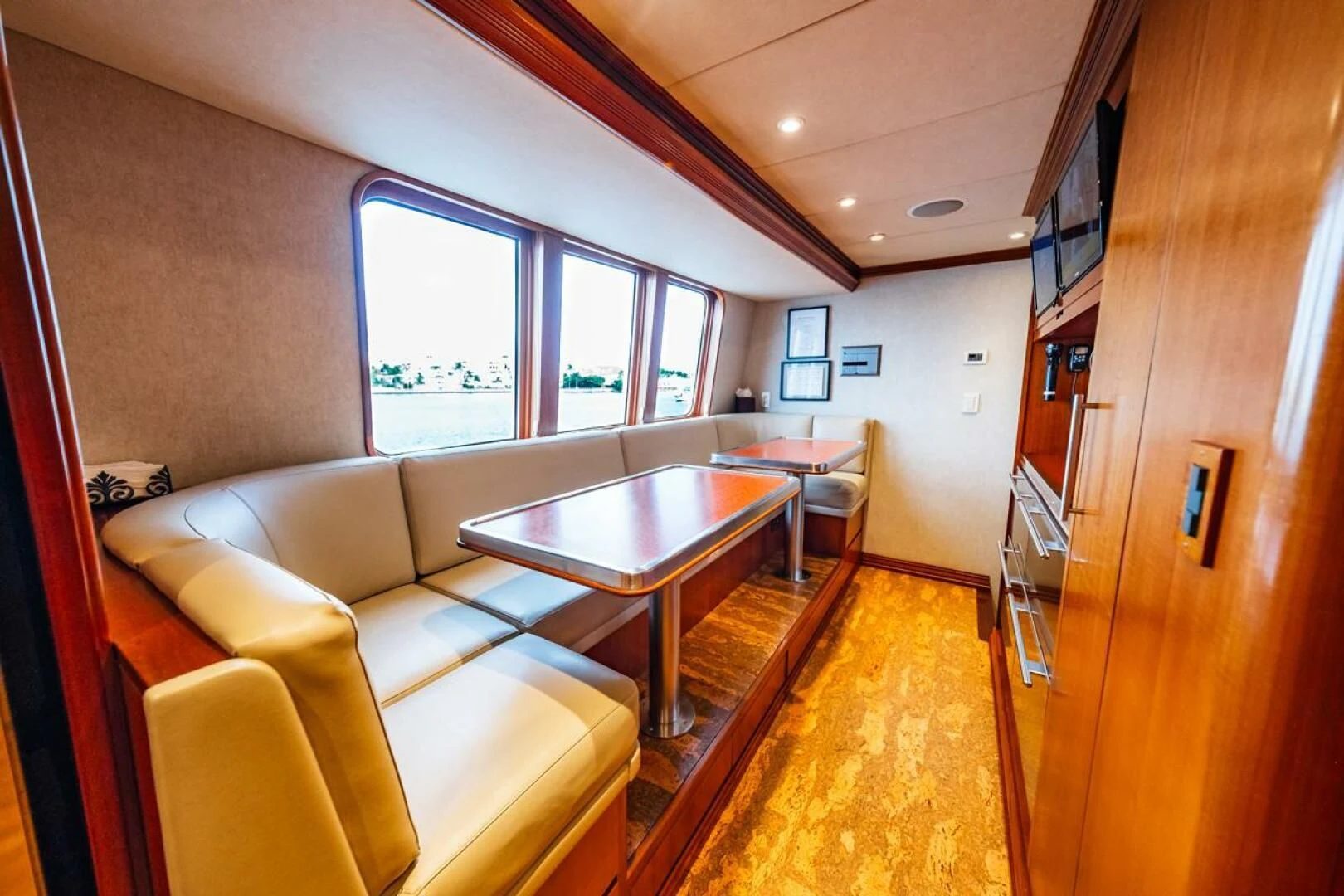 a living room with a table and couches aboard LEGACY Yacht for Sale