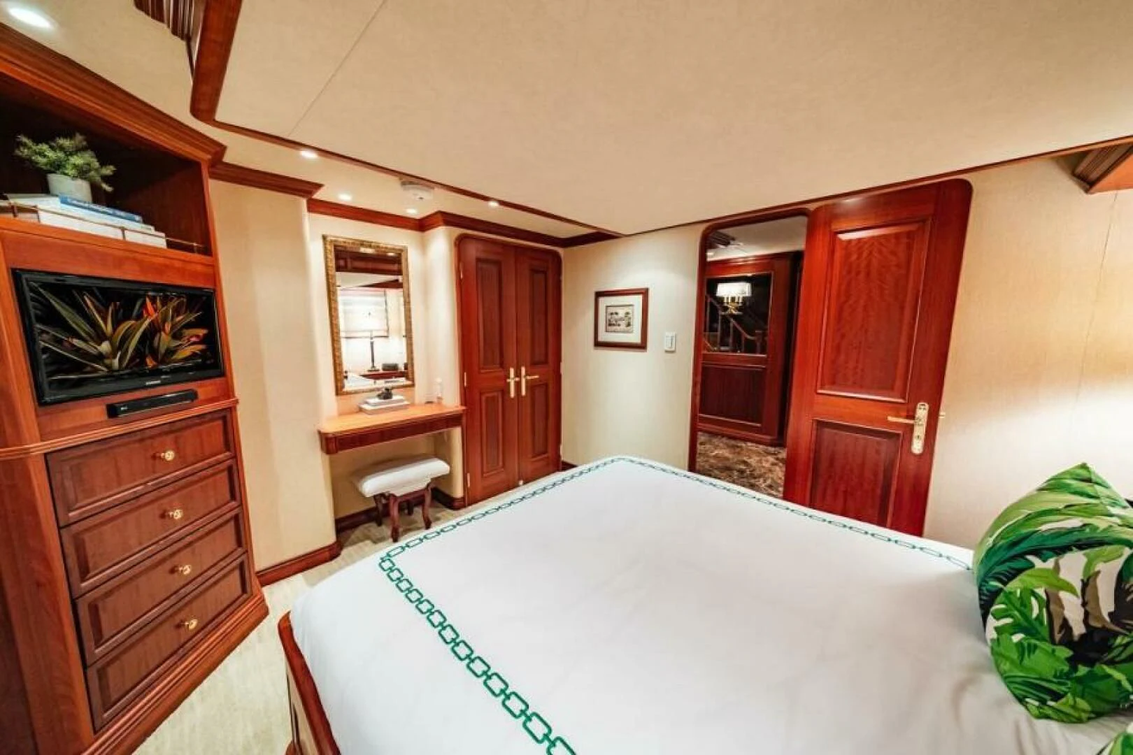 a room with a table and a television aboard LEGACY Yacht for Sale