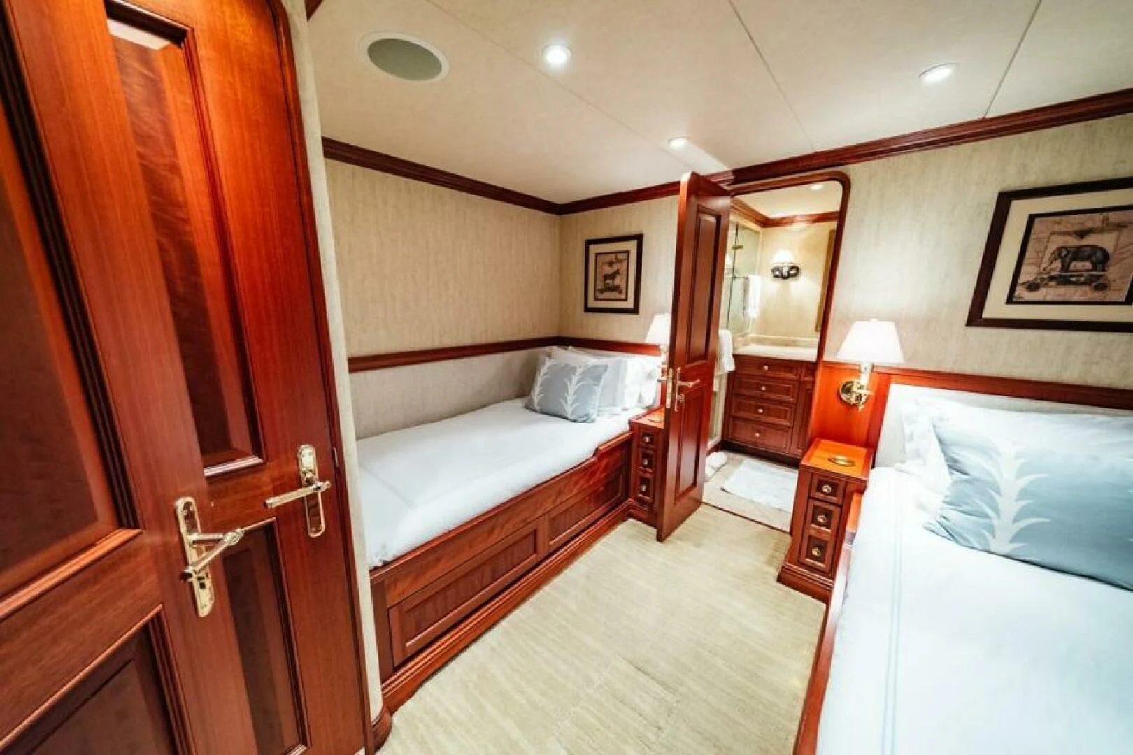 a room with a bed and a mirror aboard LEGACY Yacht for Sale