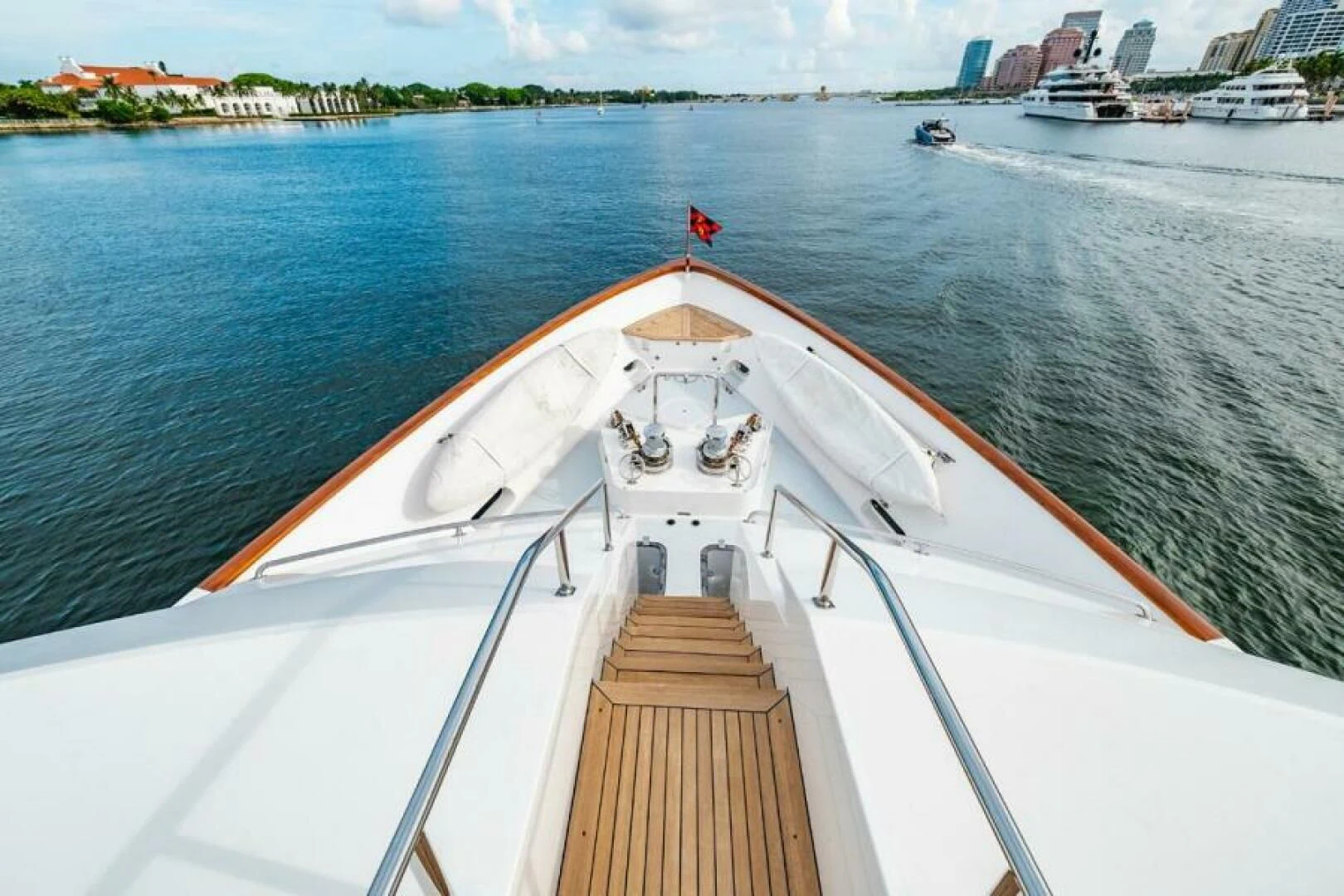 a long white boat on a body of water aboard LEGACY Yacht for Sale