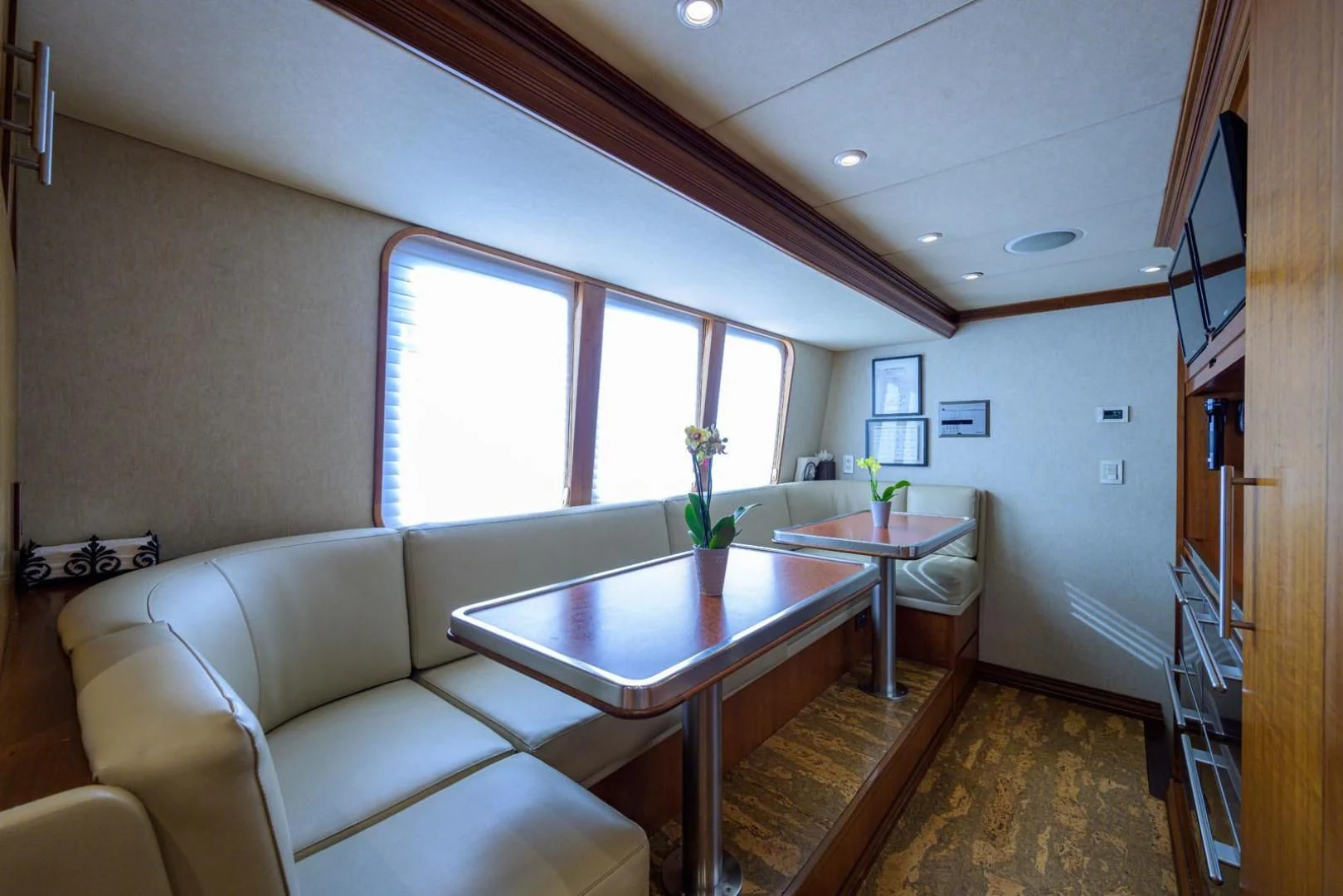 a living room with a table and couches aboard LEGACY Yacht for Sale