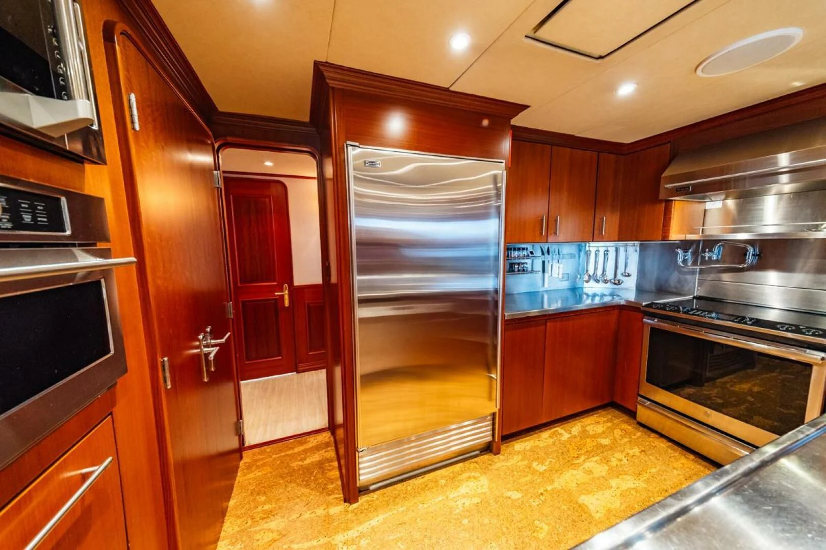 a kitchen with wooden cabinets aboard LEGACY Yacht for Sale