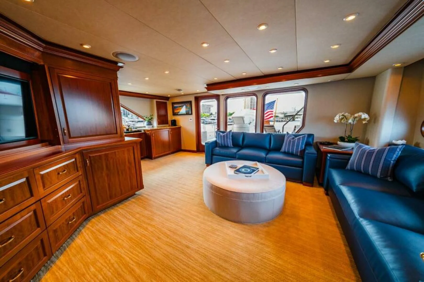 a living room with a large wood cabinet and a large wood floor aboard LEGACY Yacht for Sale