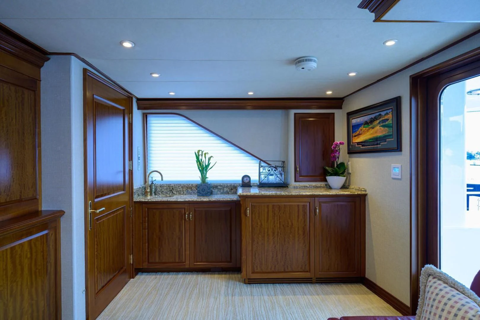 a kitchen with wooden cabinets aboard LEGACY Yacht for Sale