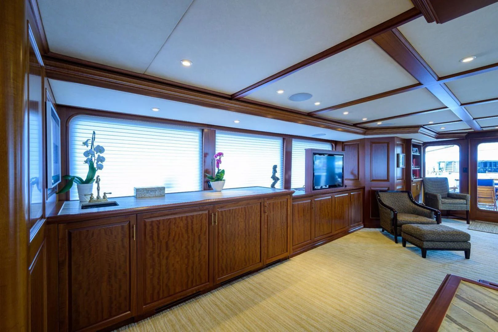 a large kitchen with wooden cabinets aboard LEGACY Yacht for Sale