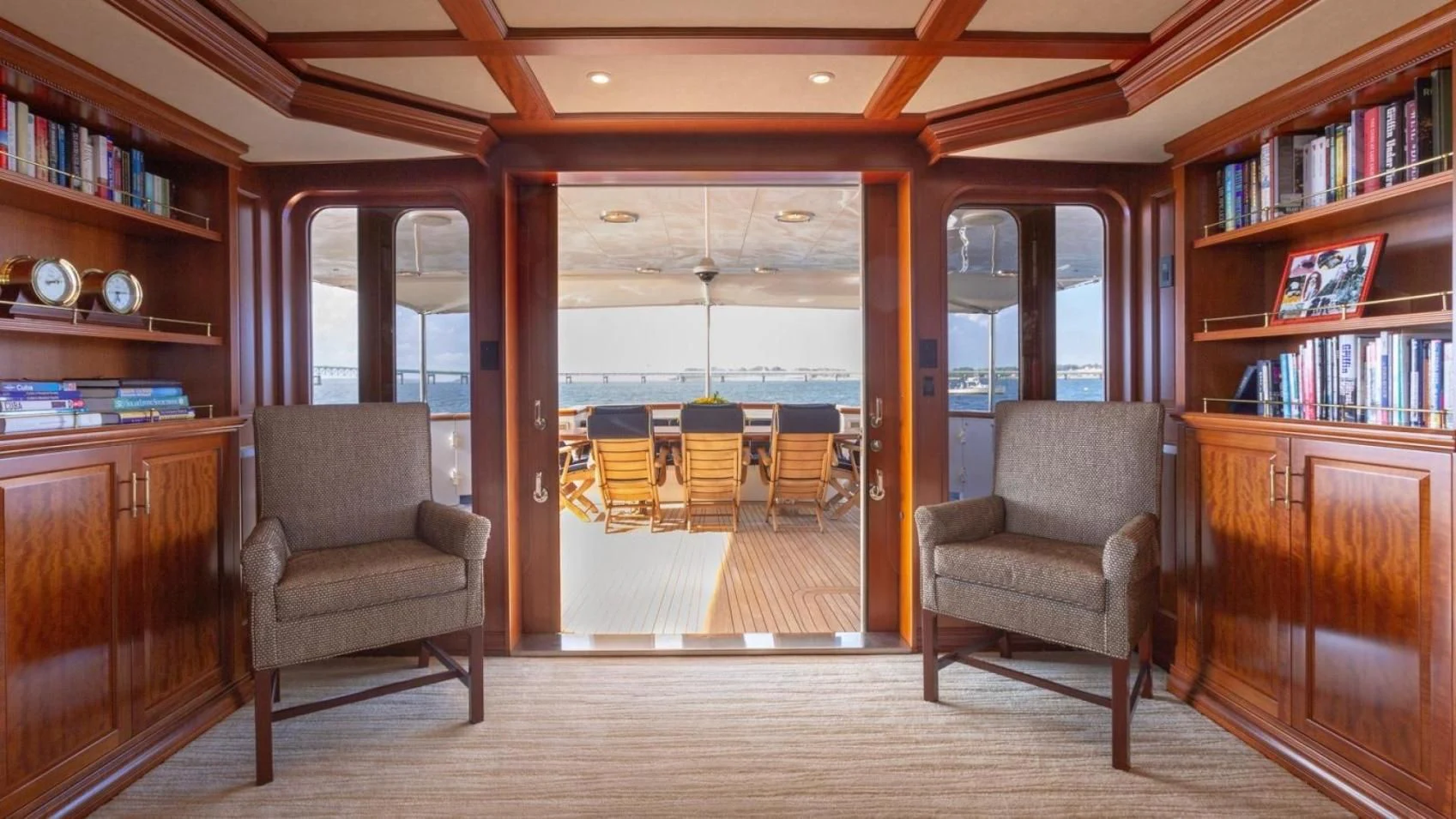 a room with a chair and a table and a couch aboard LEGACY Yacht for Sale