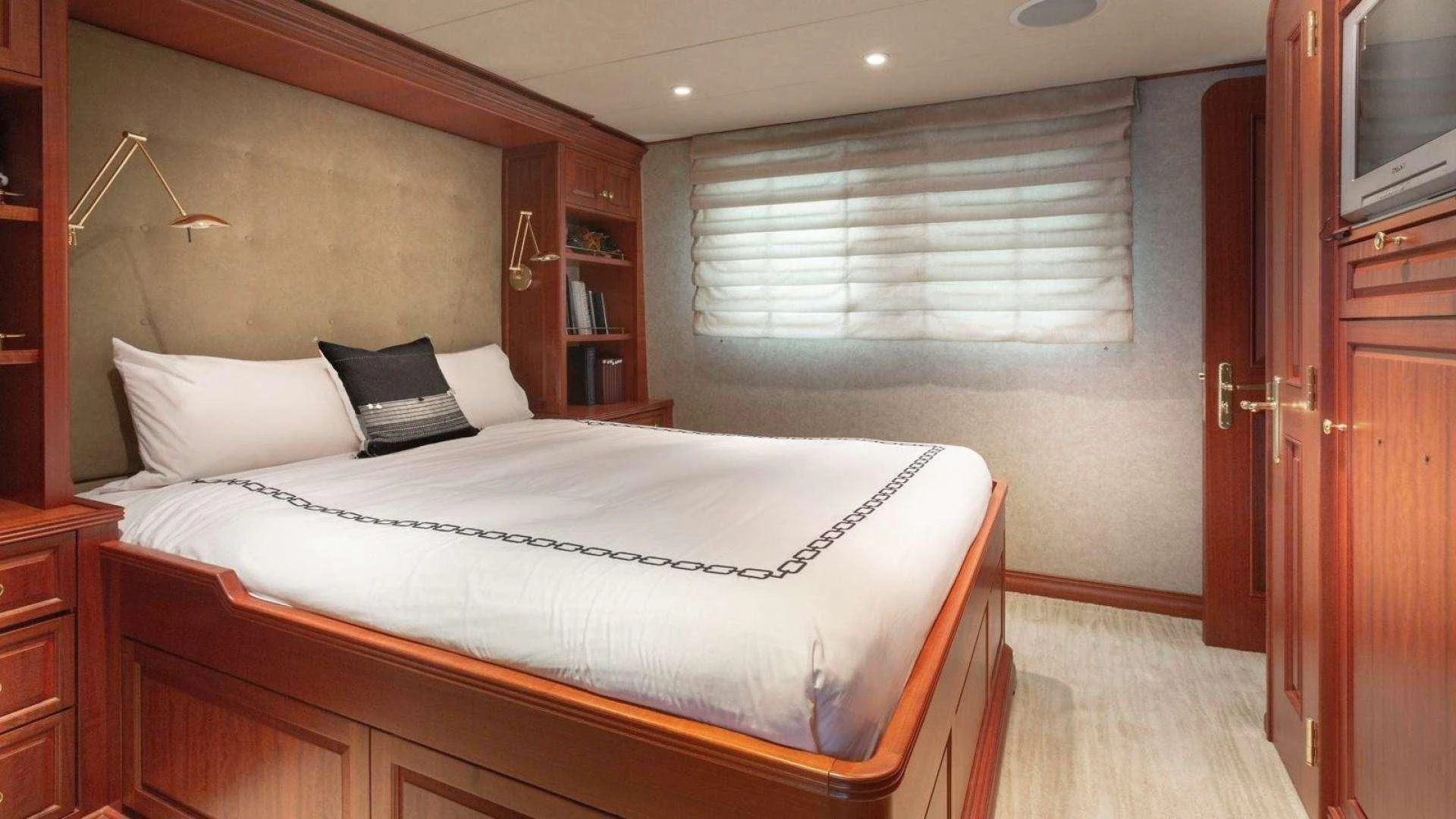 a bedroom with a bed and a desk aboard LEGACY Yacht for Sale