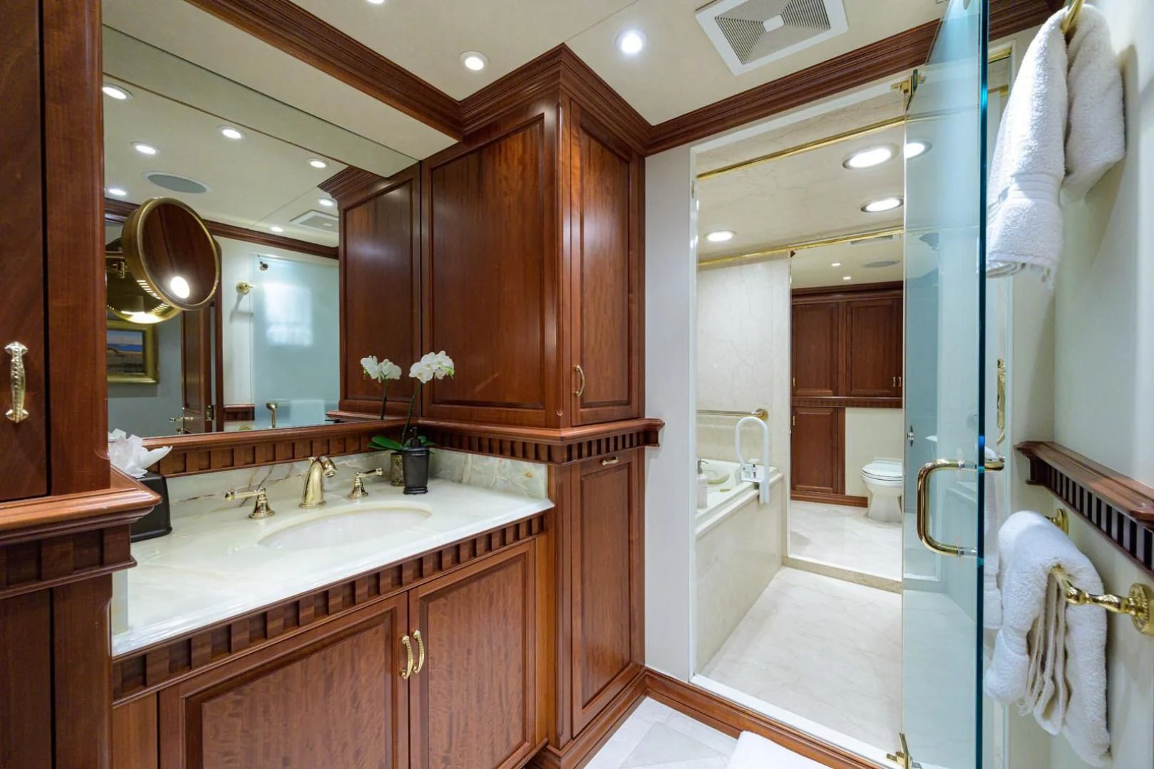 a bathroom with a large mirror aboard LEGACY Yacht for Sale