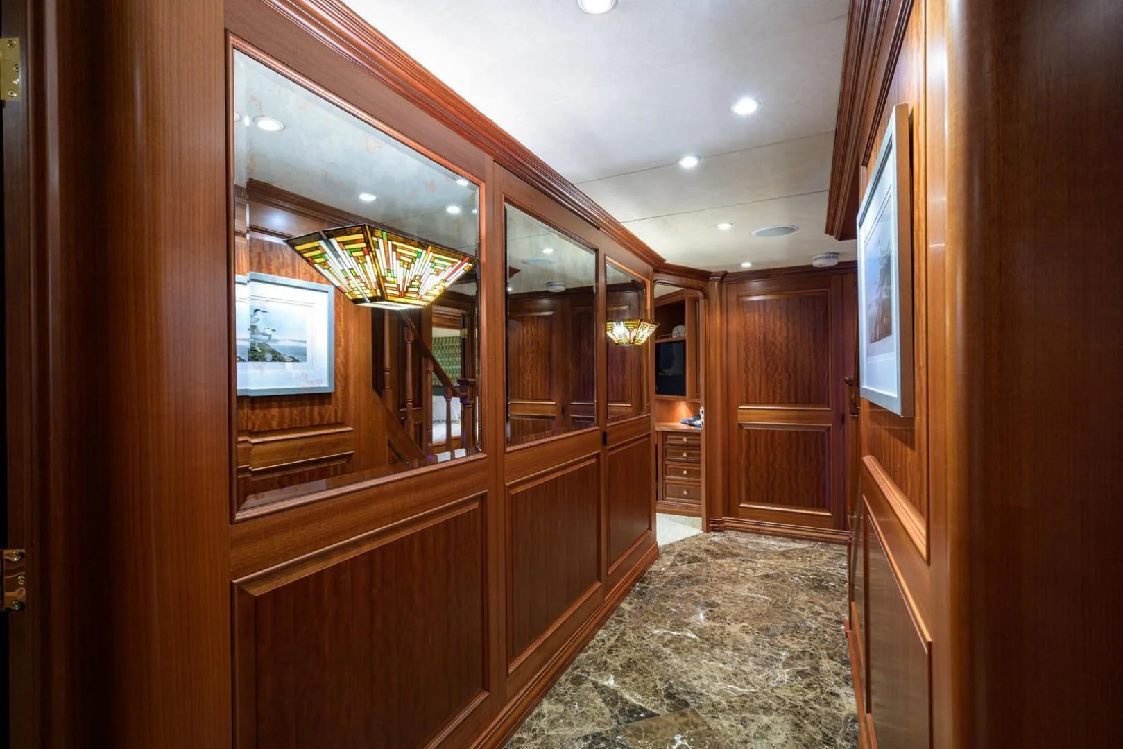 a room with wooden cabinets aboard LEGACY Yacht for Sale