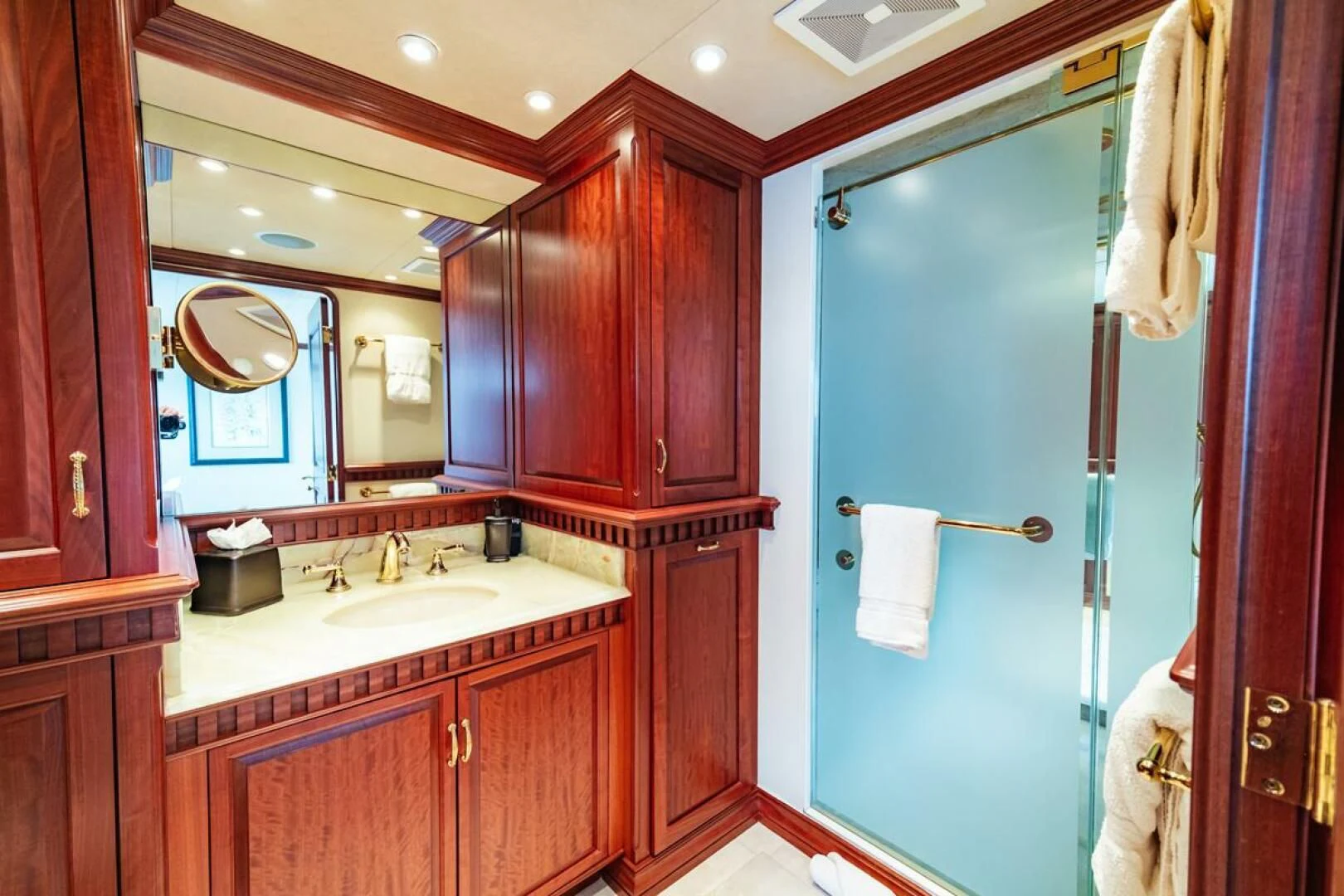 a bathroom with a blue door aboard LEGACY Yacht for Sale