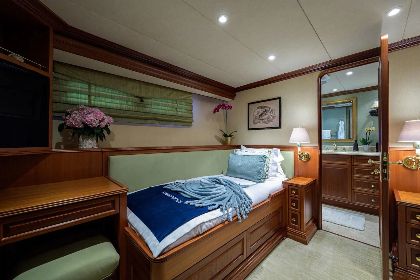 a bedroom with a bed and a mirror aboard LEGACY Yacht for Sale
