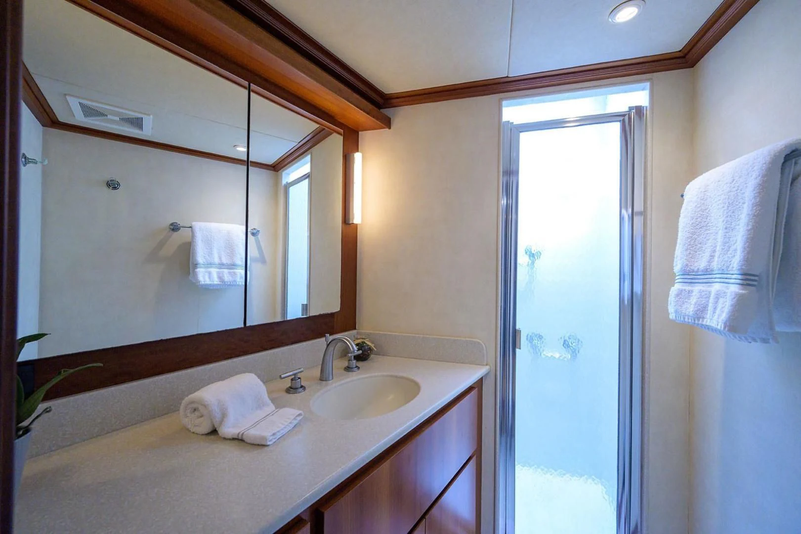 a bathroom with a sink and mirror aboard LEGACY Yacht for Sale