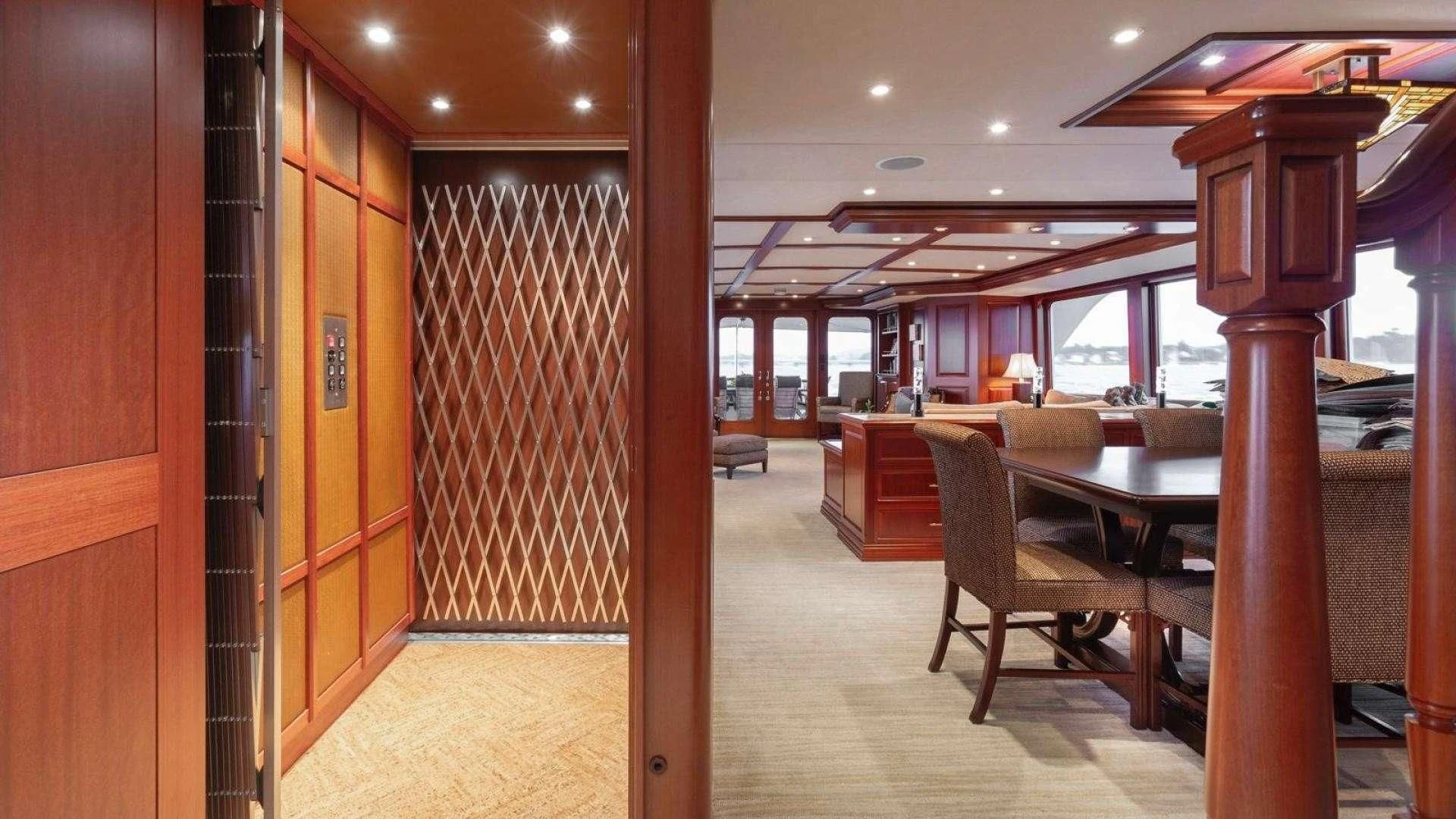 a room with a table and chairs aboard LEGACY Yacht for Sale
