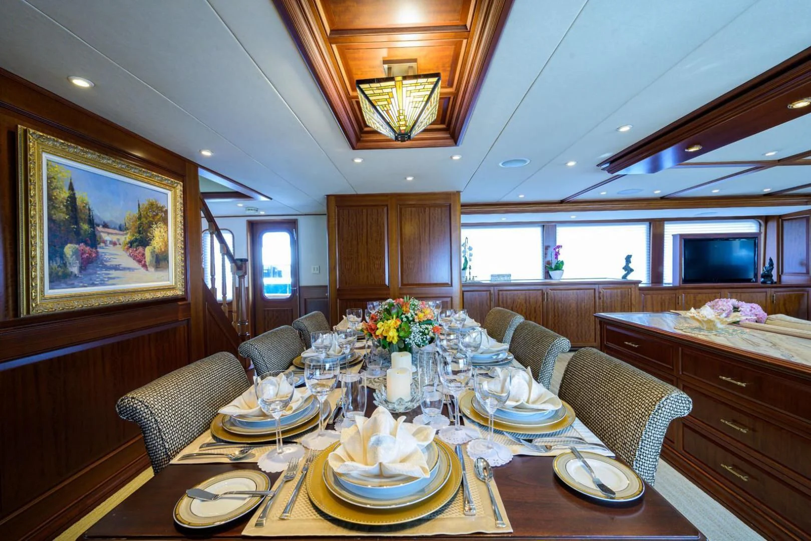 a large kitchen with a dining table aboard LEGACY Yacht for Sale