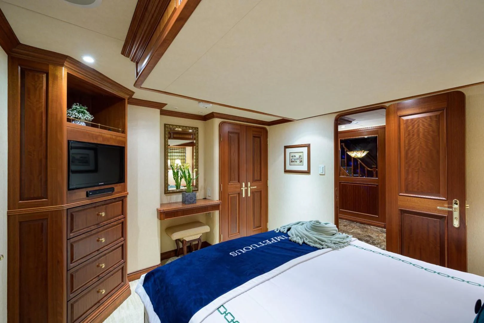 a bedroom with a bed and a television aboard LEGACY Yacht for Sale