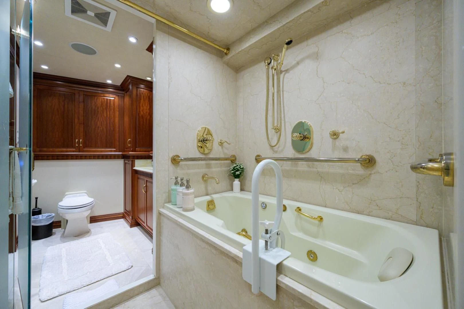 a bathroom with a tub sink and toilet aboard LEGACY Yacht for Sale