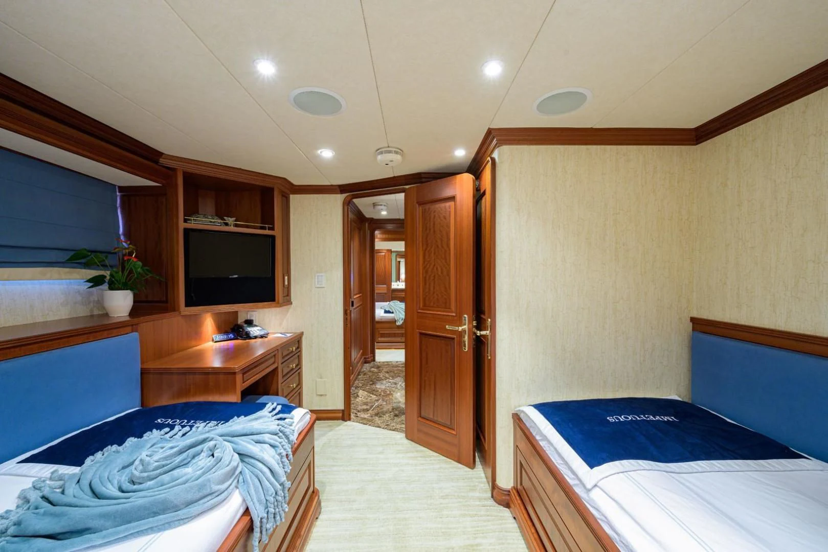 a room with a bed and a television aboard LEGACY Yacht for Sale