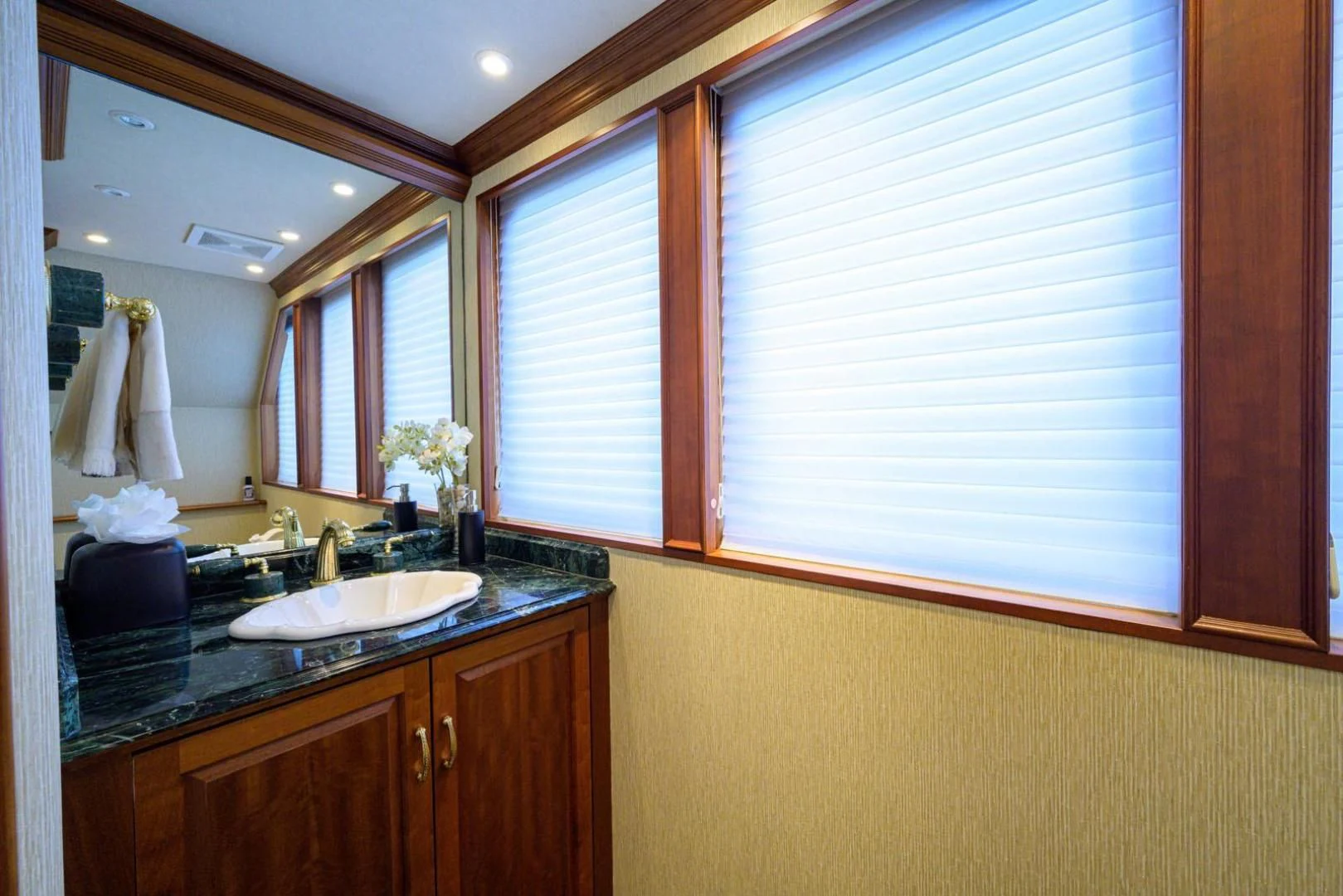 a bathroom with a sink and a mirror aboard LEGACY Yacht for Sale