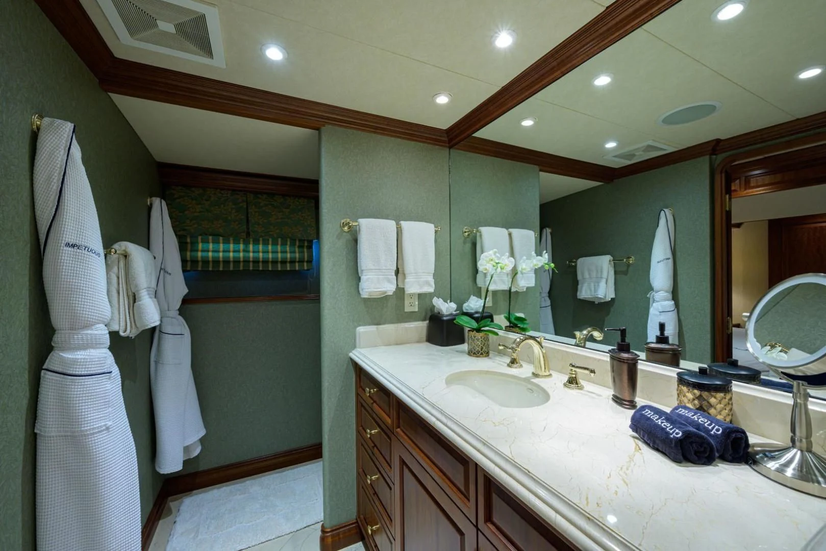 a bathroom with a large mirror aboard LEGACY Yacht for Sale