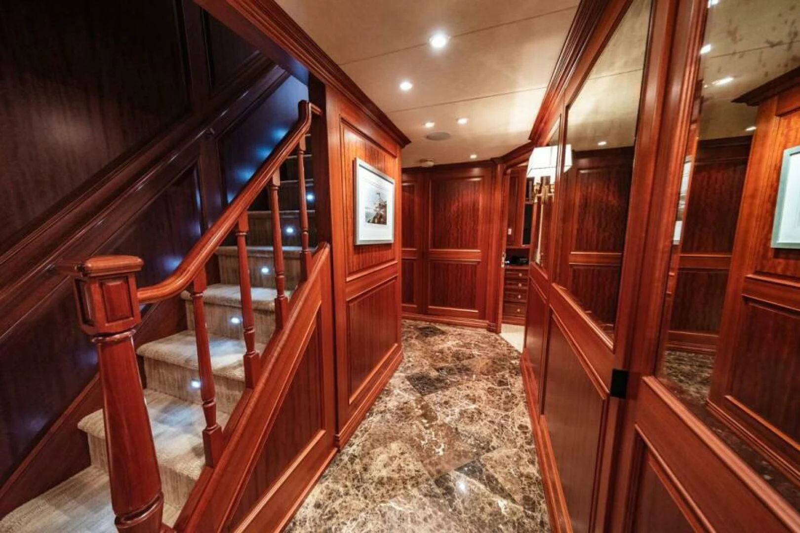 a wood staircase in a room aboard LEGACY Yacht for Sale