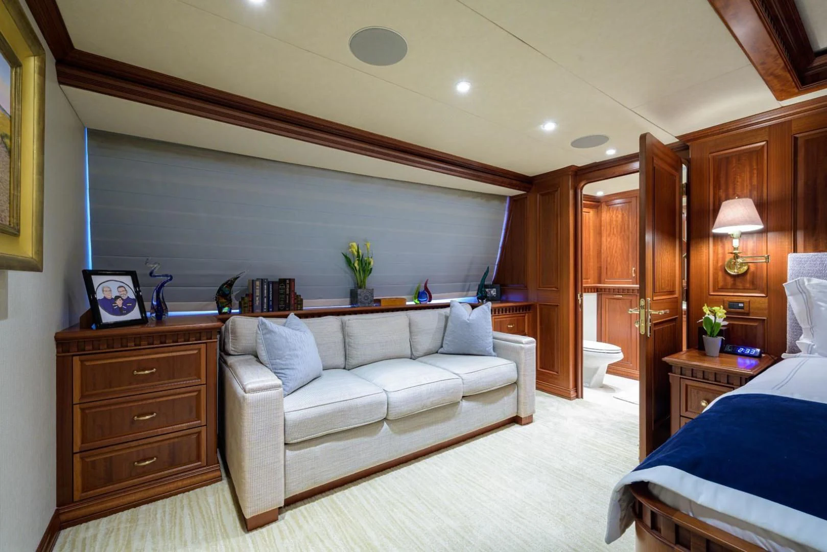 a room with a bed and a couch aboard LEGACY Yacht for Sale