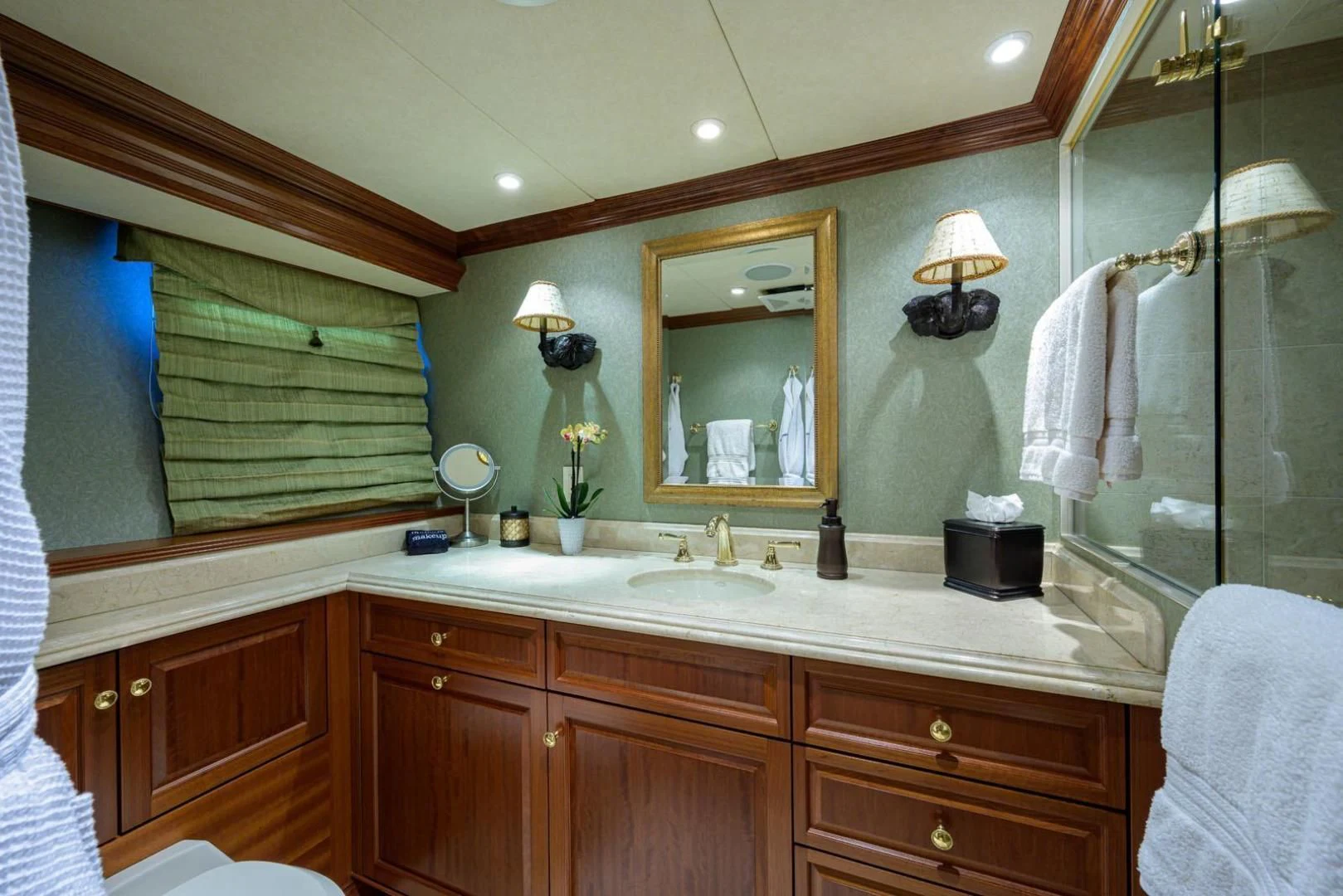 a bathroom with a large mirror aboard LEGACY Yacht for Sale
