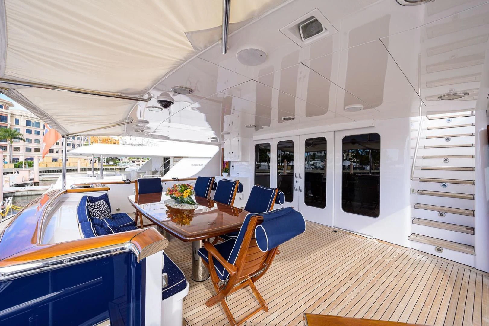 a boat with a table and chairs aboard LEGACY Yacht for Sale