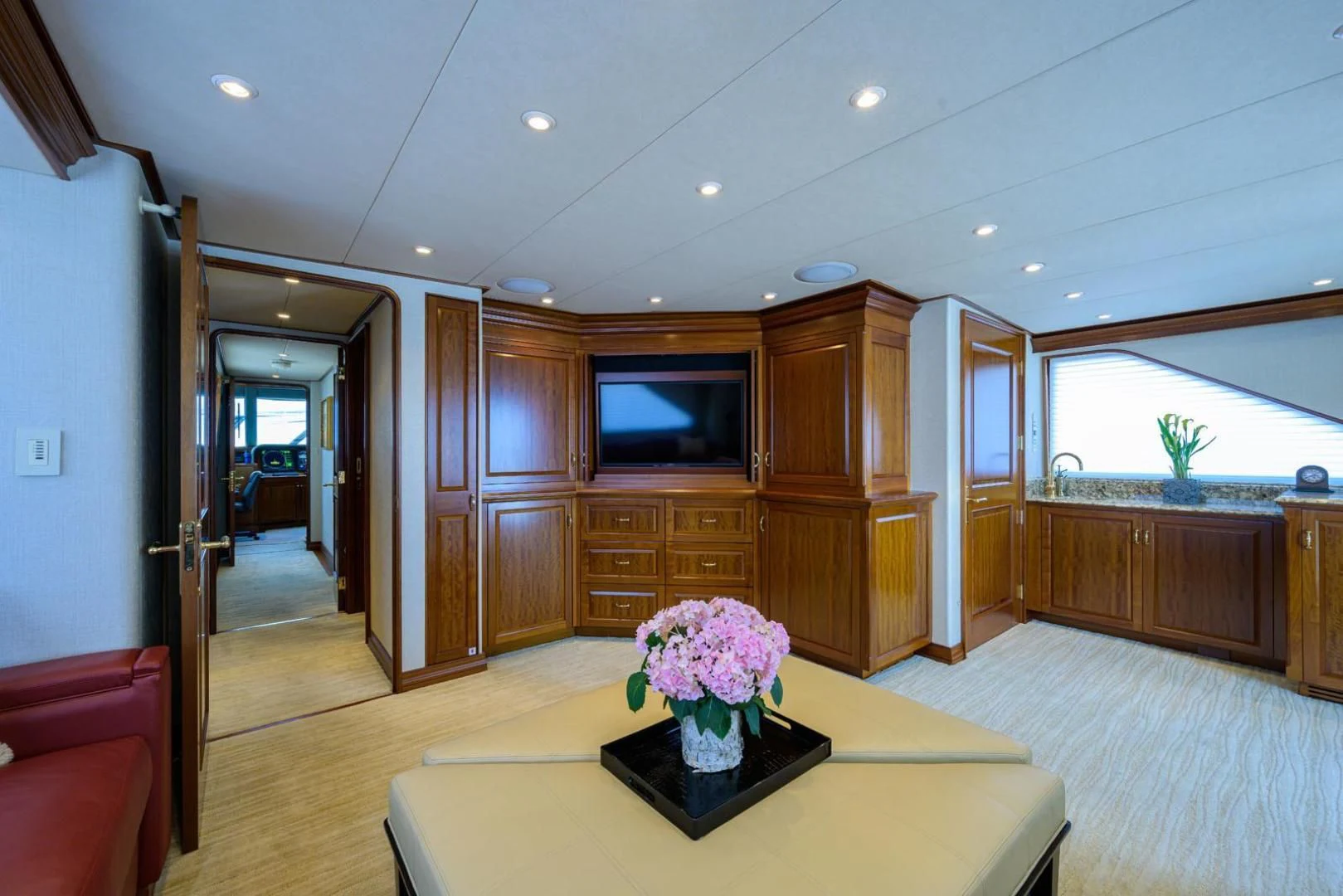 a large room with a table and a tv aboard LEGACY Yacht for Sale