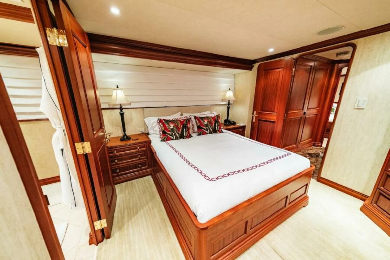 a bedroom with a bed and a closet aboard LEGACY Yacht for Sale
