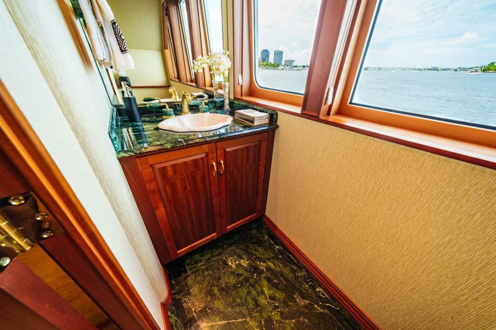 a bathroom with a sink and a window aboard LEGACY Yacht for Sale