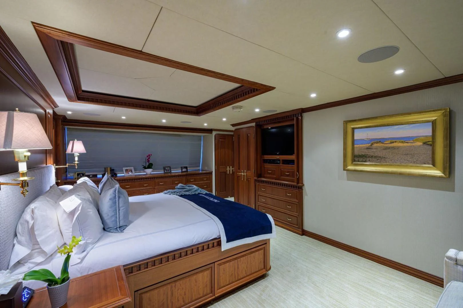 a bedroom with a bed and a desk aboard LEGACY Yacht for Sale