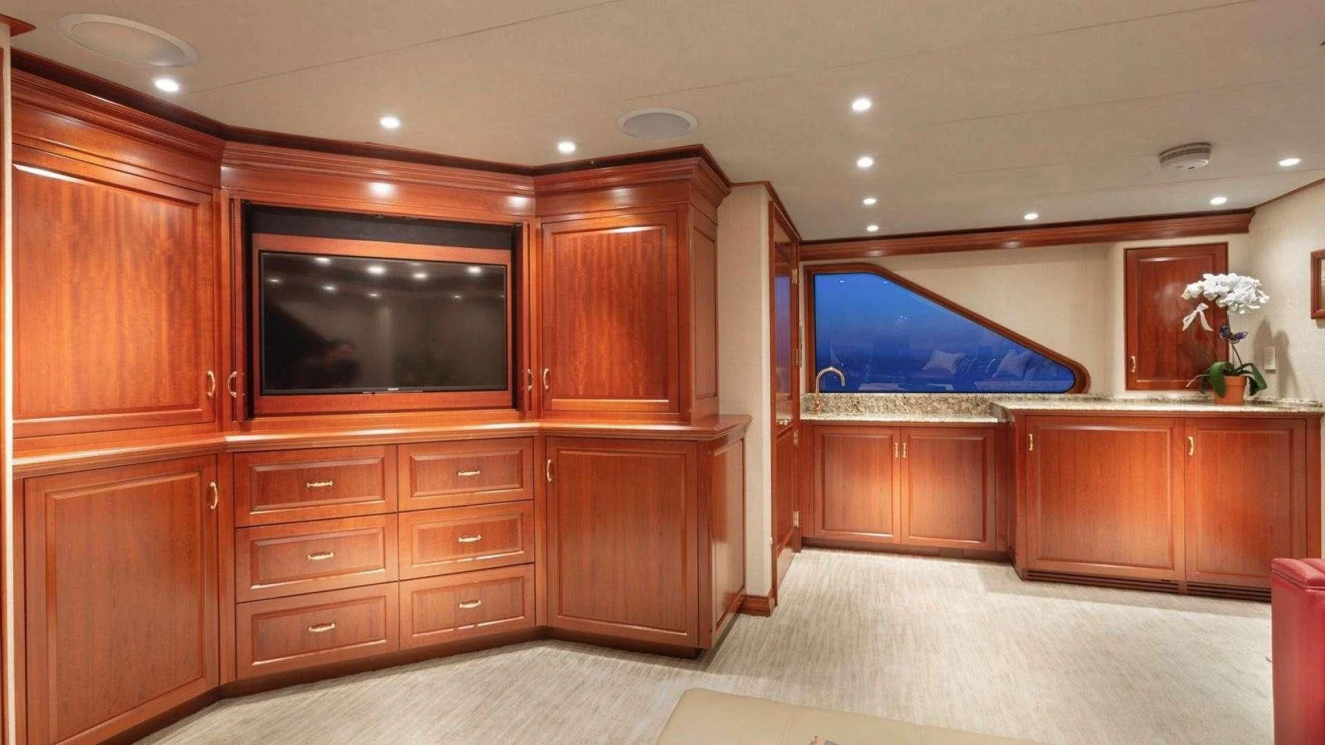 a room with wooden cabinets aboard LEGACY Yacht for Sale