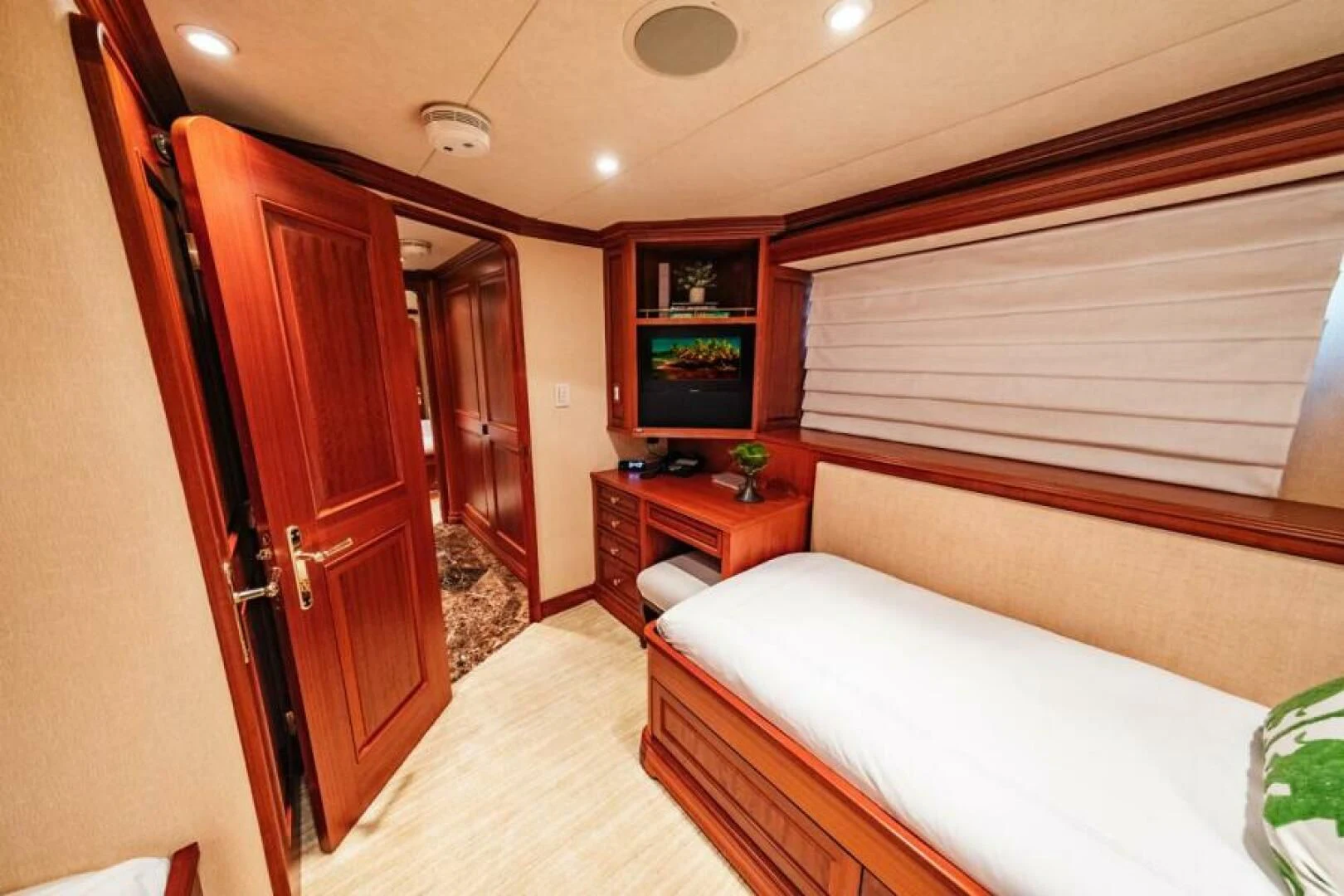 a bedroom with a bed and a television aboard LEGACY Yacht for Sale