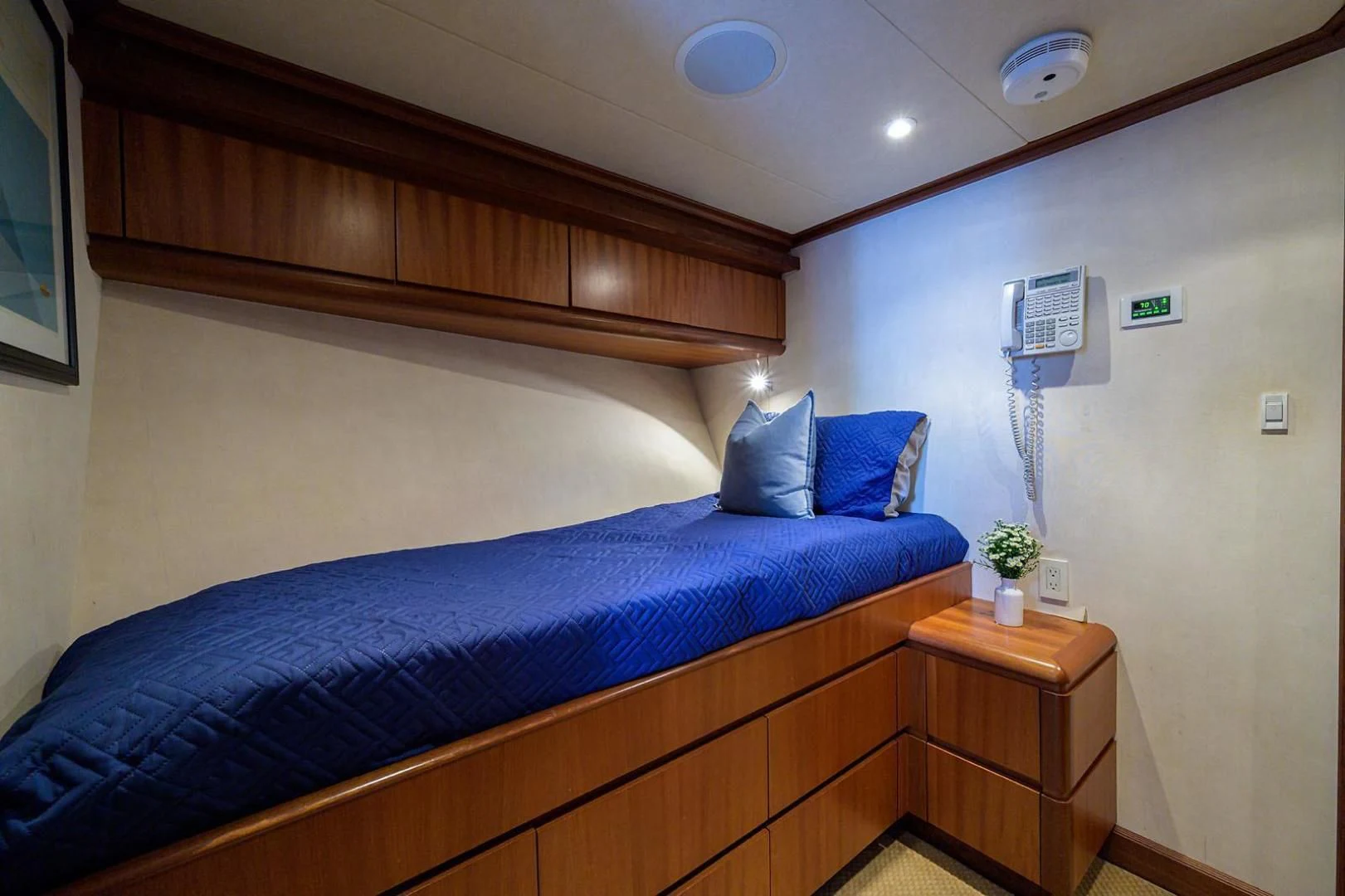 a bed with a blue comforter aboard LEGACY Yacht for Sale
