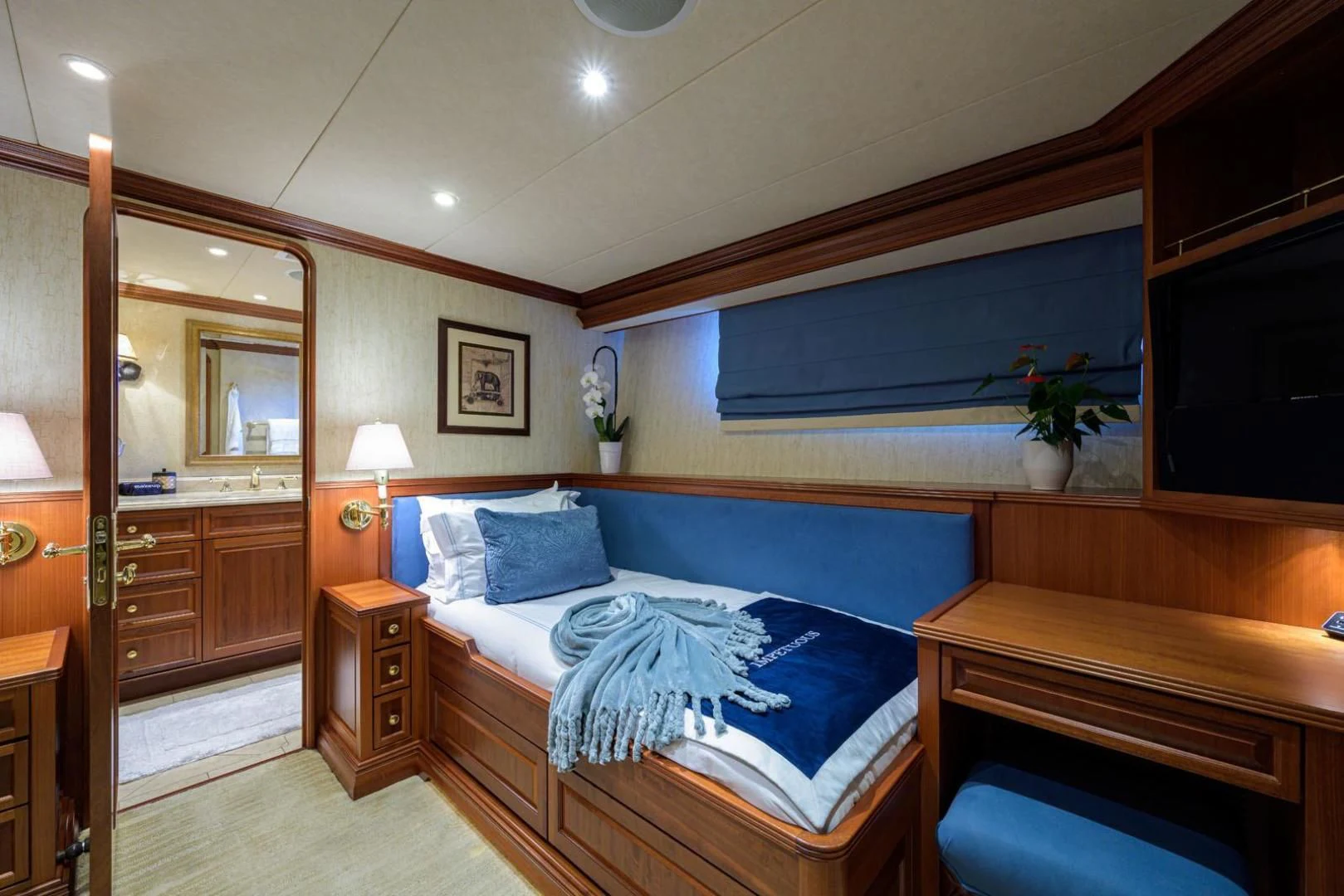 a bedroom with a bed and a mirror aboard LEGACY Yacht for Sale