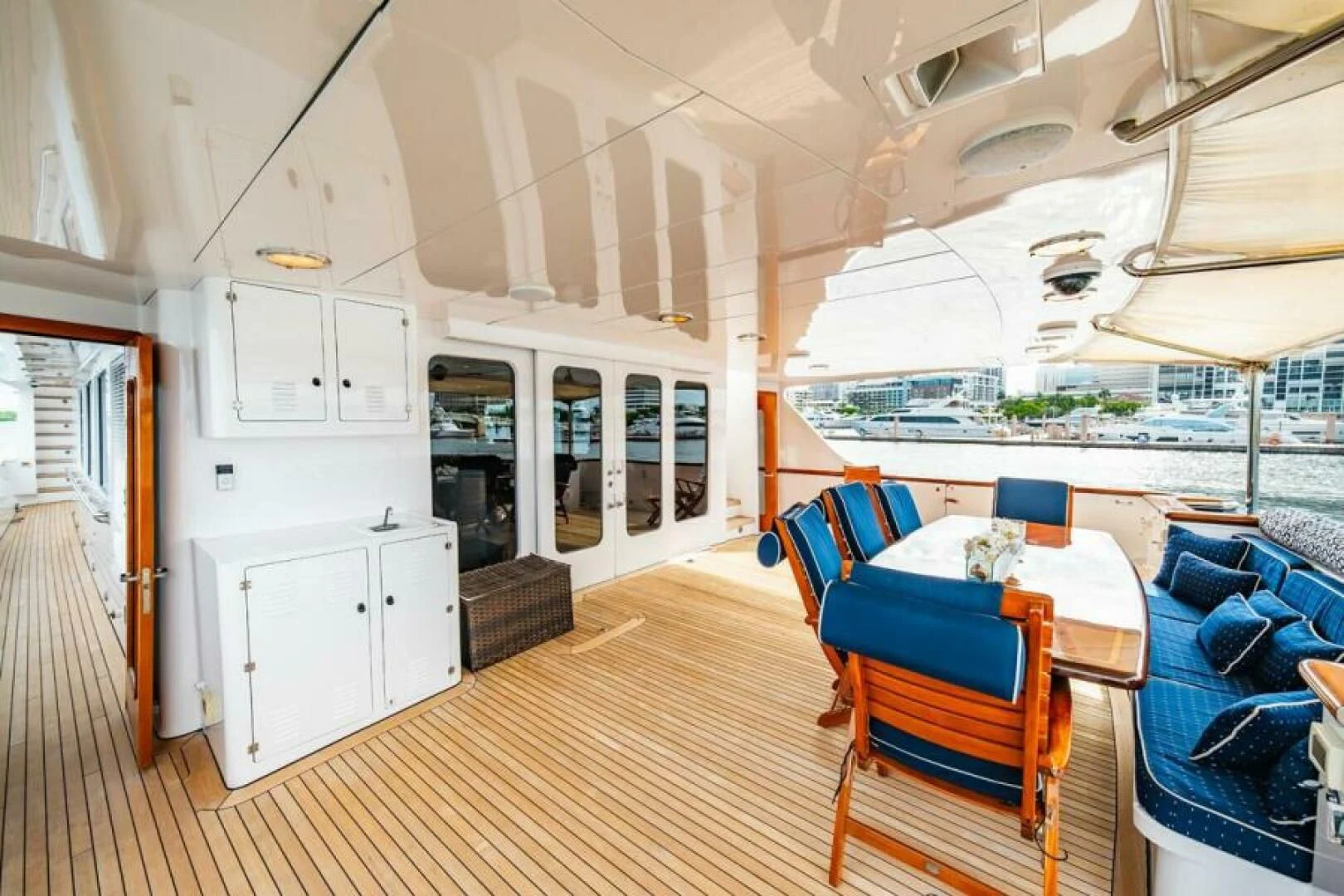 a large room with a table and chairs and a large window aboard LEGACY Yacht for Sale