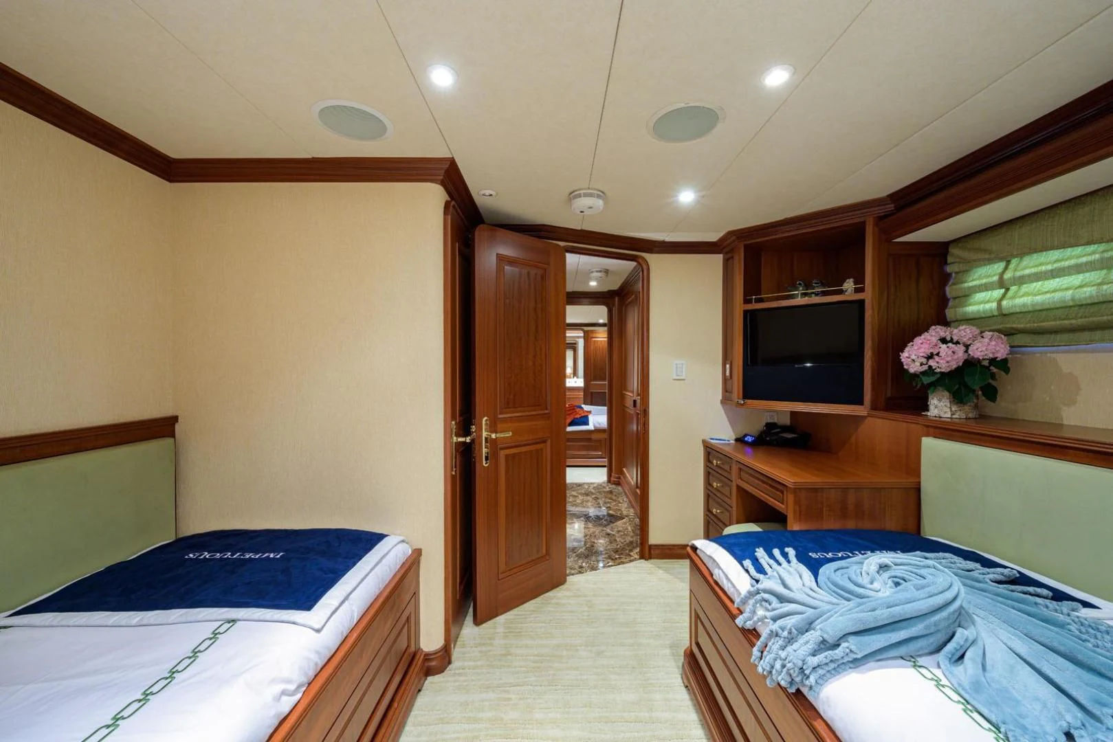 a room with a bed and a television aboard LEGACY Yacht for Sale