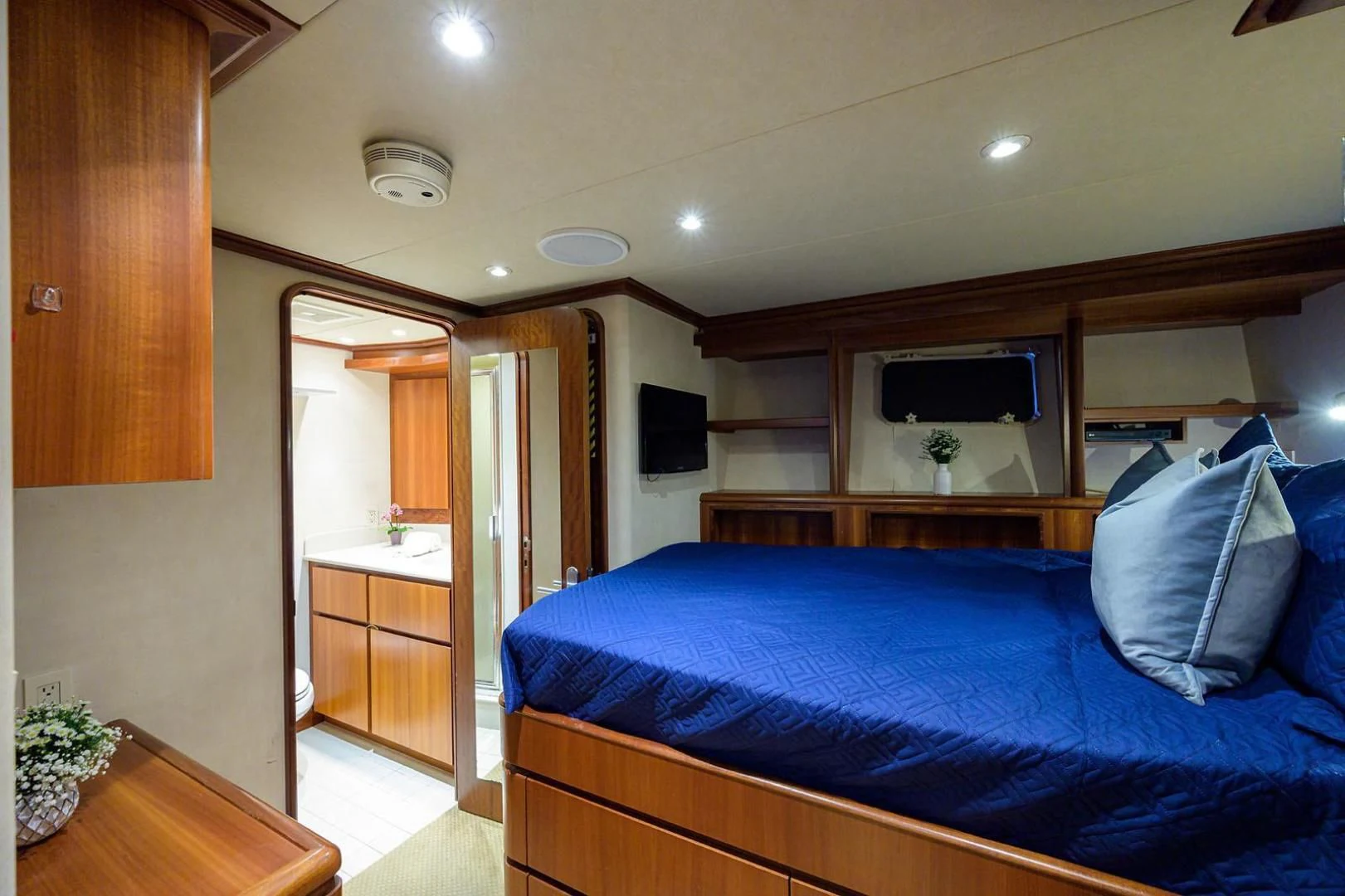 a bedroom with a blue bed aboard LEGACY Yacht for Sale