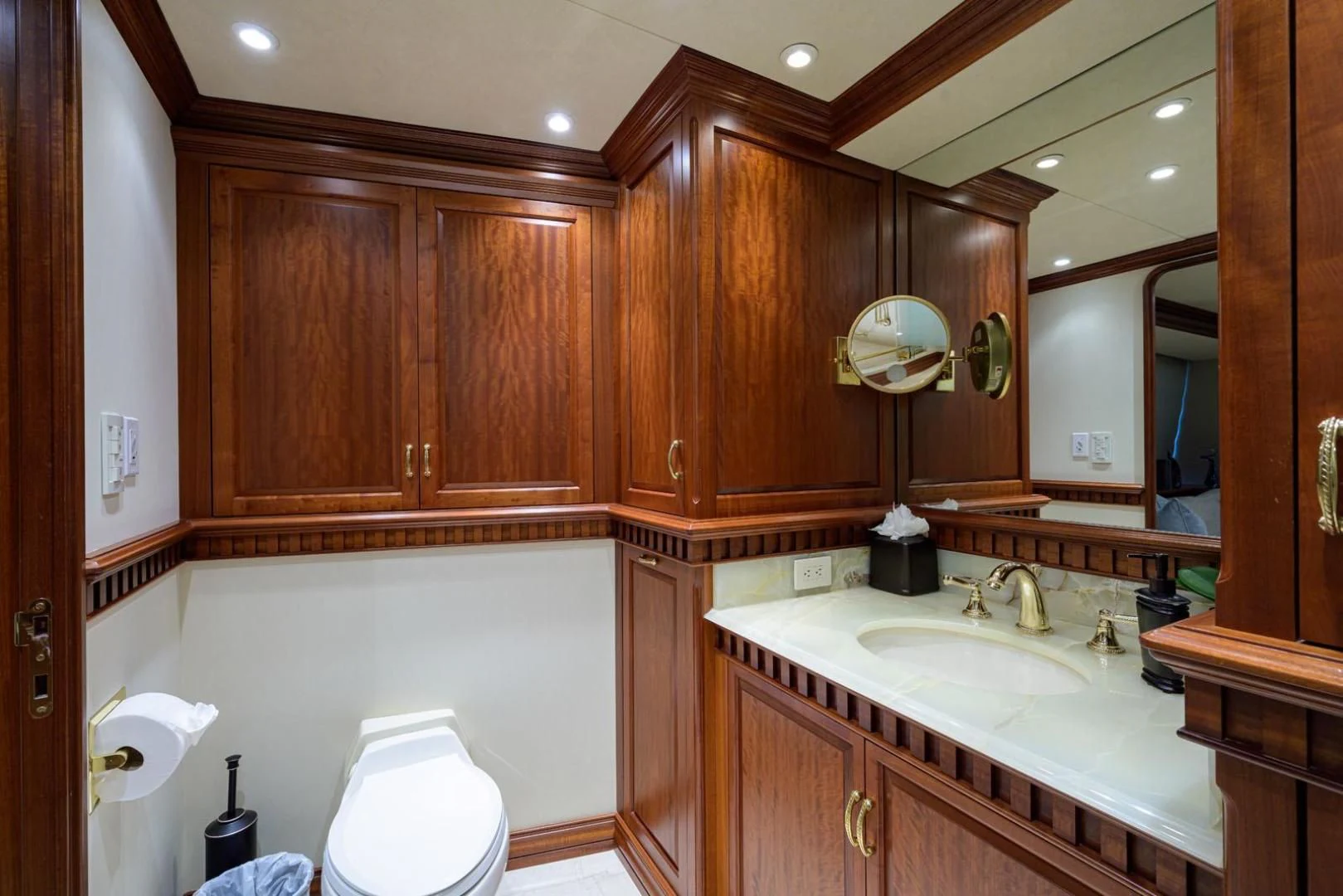 a bathroom with wooden cabinets aboard LEGACY Yacht for Sale