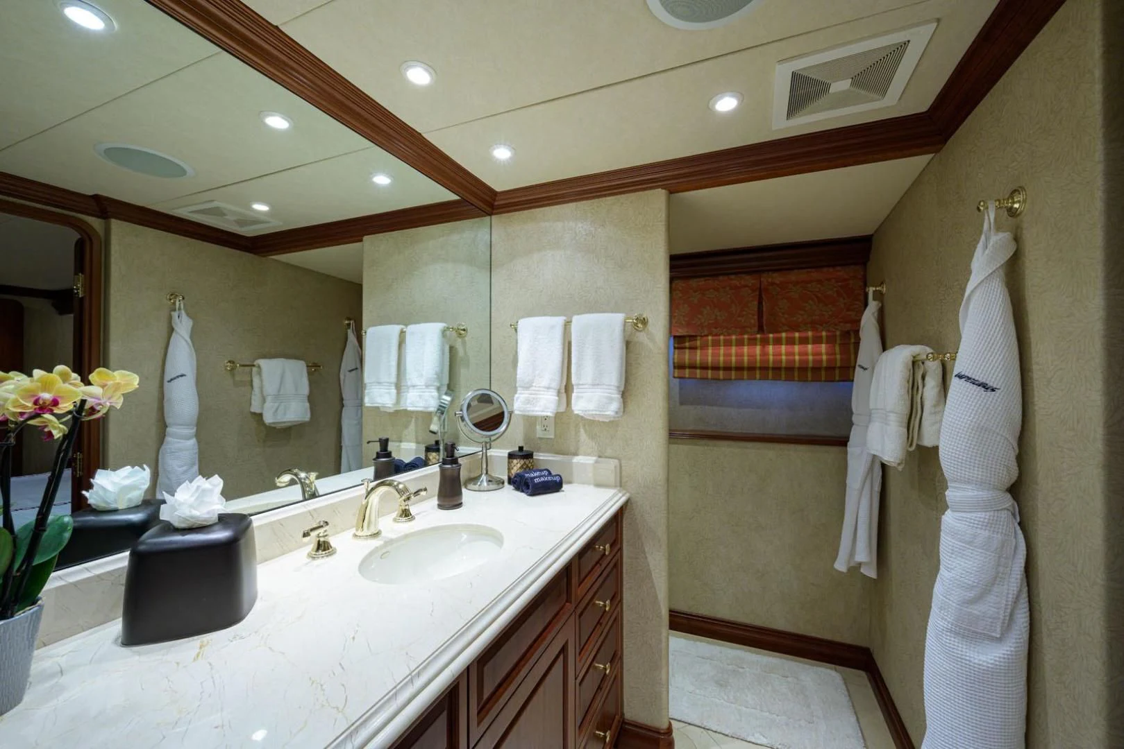 a bathroom with a large mirror aboard LEGACY Yacht for Sale