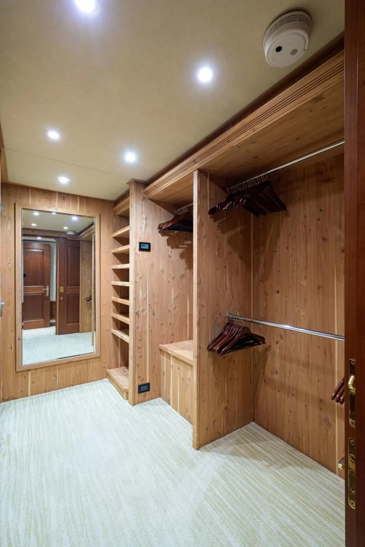 a wooden closet with a mirror aboard LEGACY Yacht for Sale