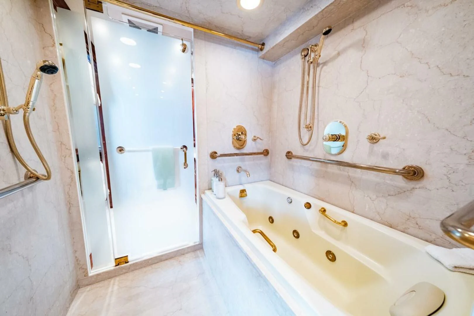 a bathroom with a bathtub and sink aboard LEGACY Yacht for Sale