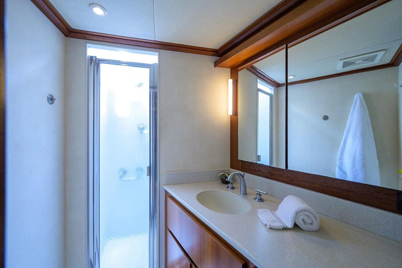 a bathroom with a sink and a mirror aboard LEGACY Yacht for Sale