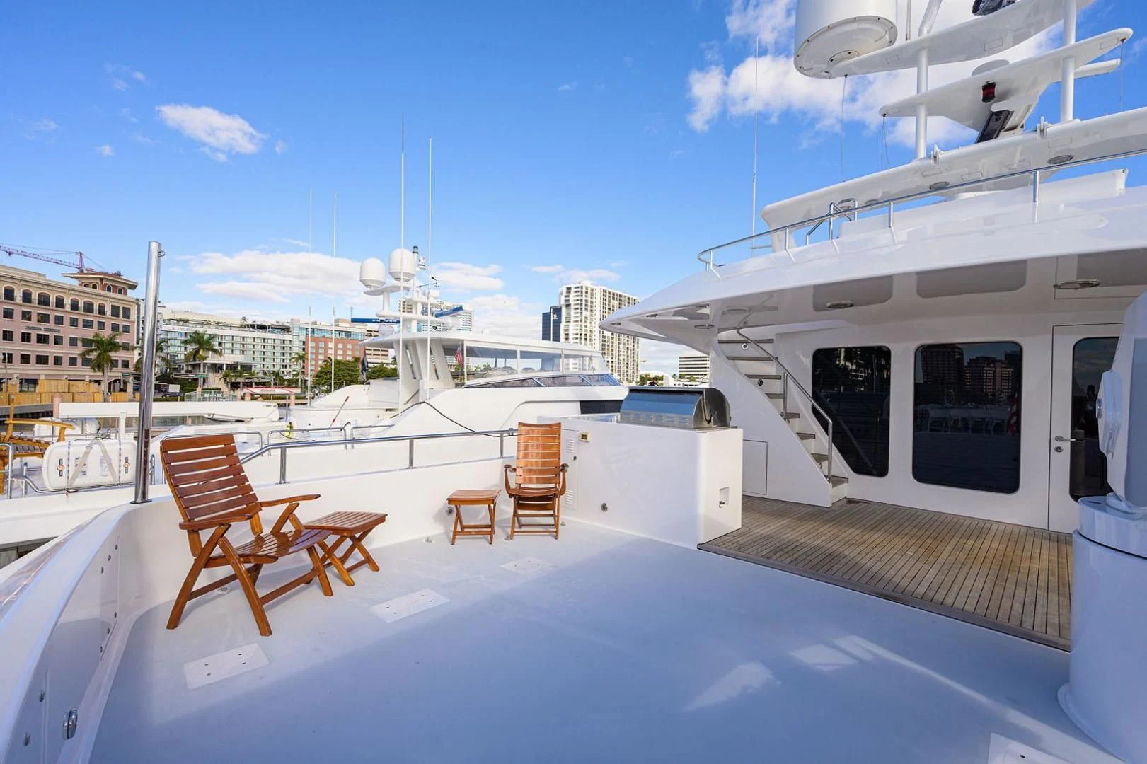 a deck with chairs and tables on it aboard LEGACY Yacht for Sale