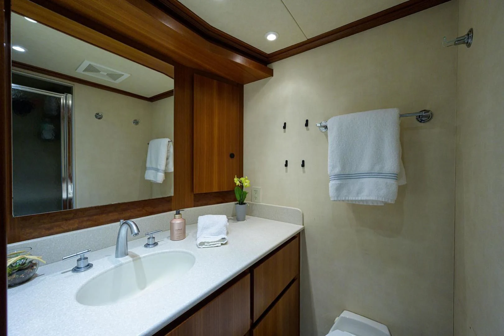 a bathroom with a large mirror aboard LEGACY Yacht for Sale