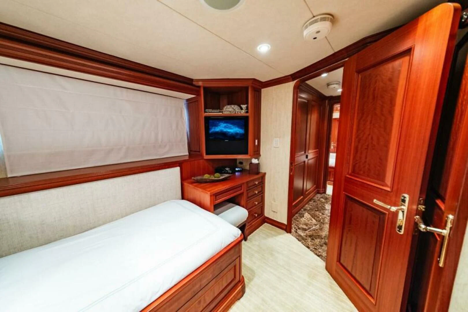 a room with a bed and a television aboard LEGACY Yacht for Sale
